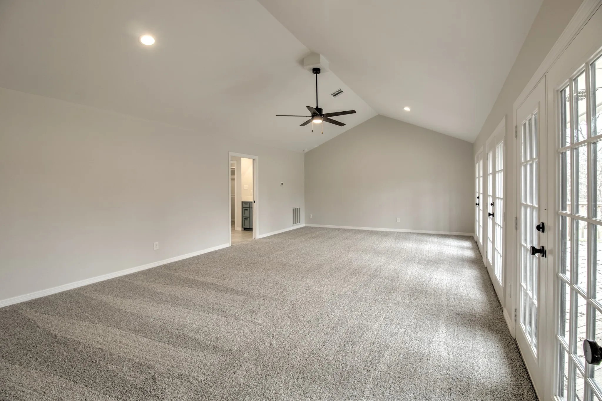 Extra Large Master Bedroom, with vaulted Ceiling and French doors opening onto the deck.