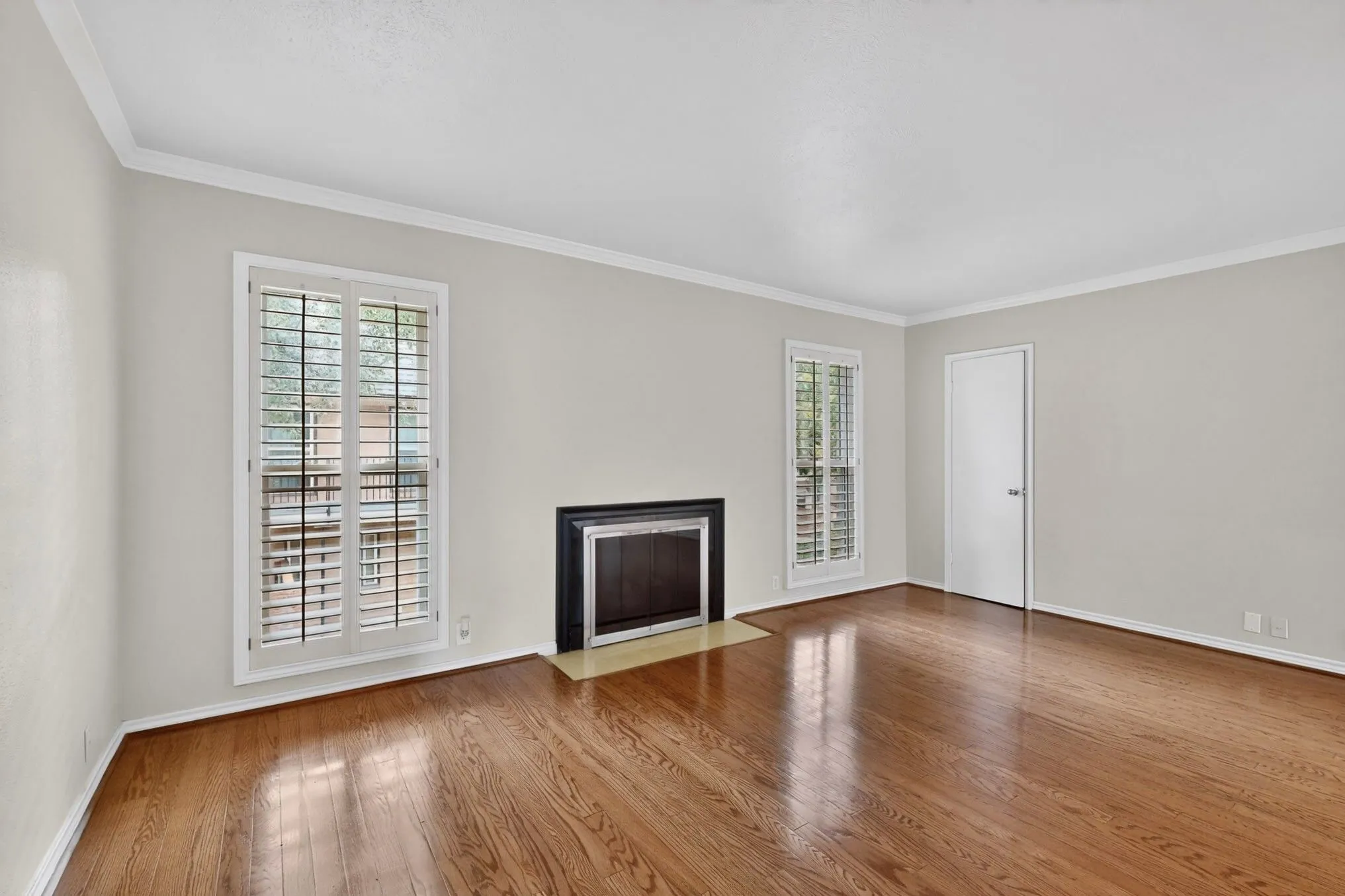 Spacious room featuring rich wood-finish flooring