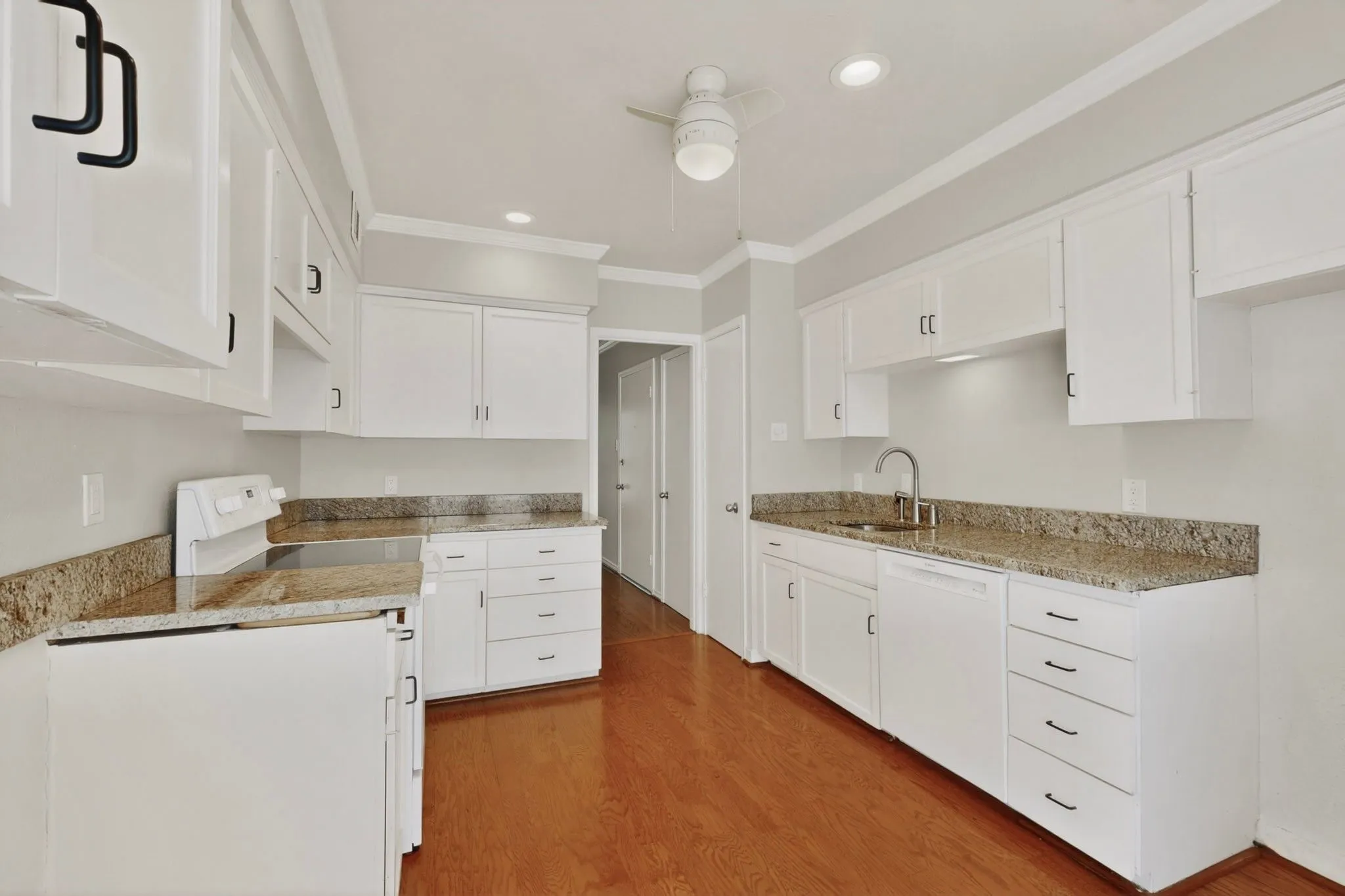 Kitchen featuring white cabinetry, granite-style countertops, wood-finish flooring, recessed lighting, and a ceiling fan
