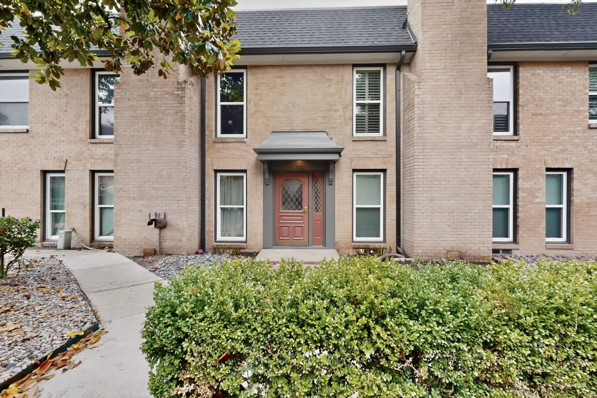Brick exterior featuring a gabled roofline and prominent chimney