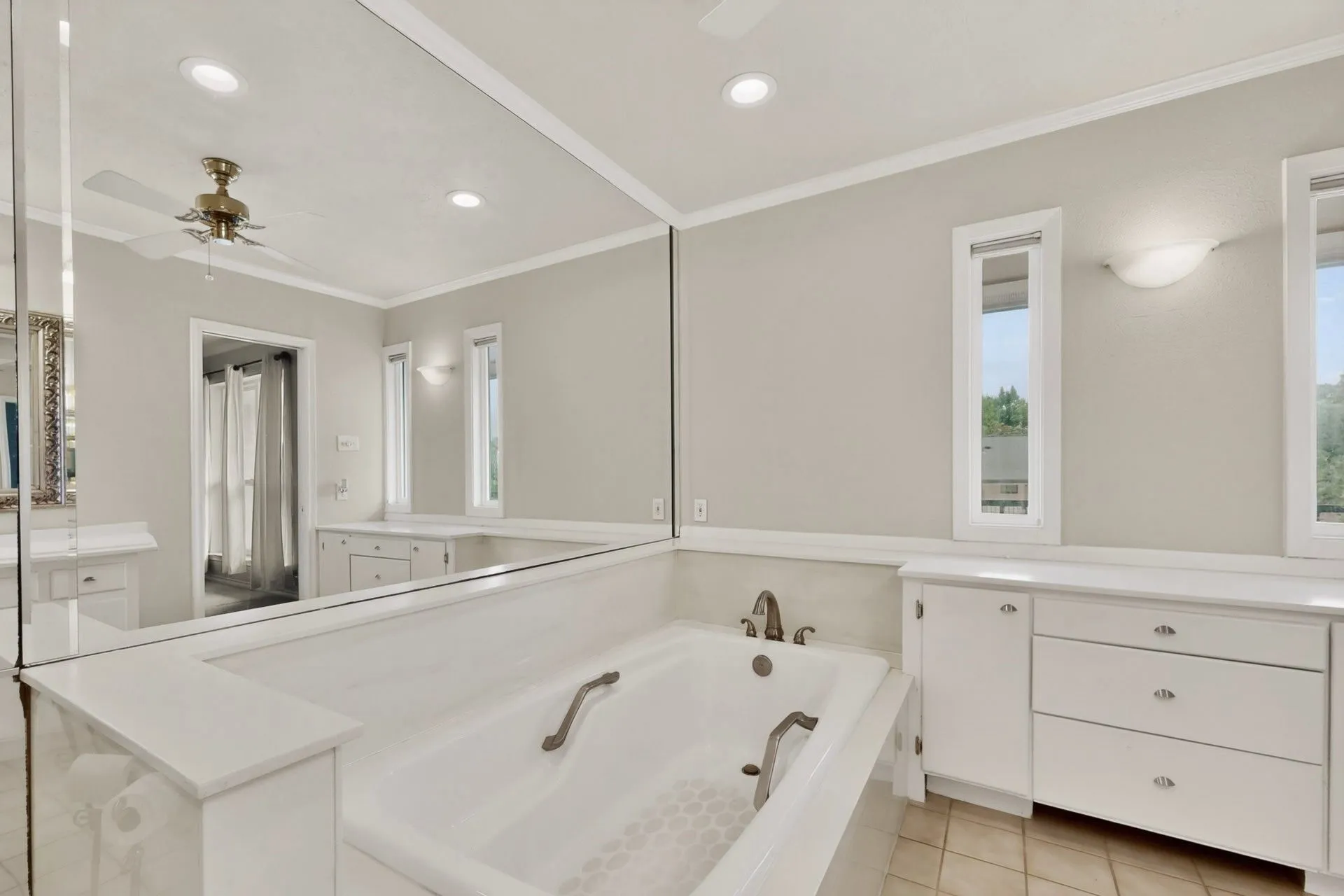 Built-in soaking tub with bronze-finish fixtures and grab bars