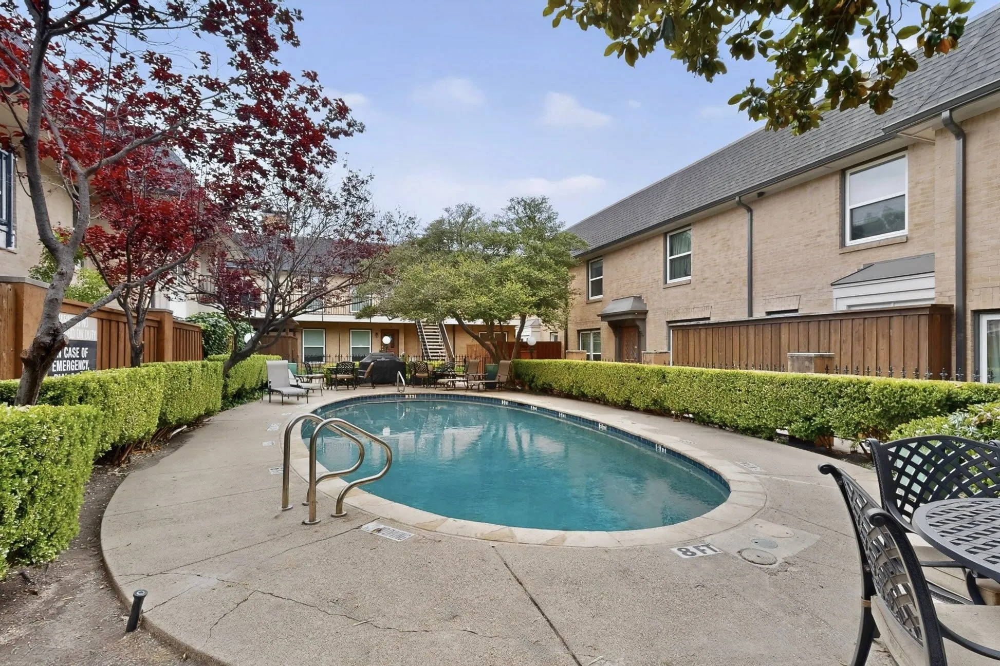 Inviting oval-shaped swimming pool with concrete surround