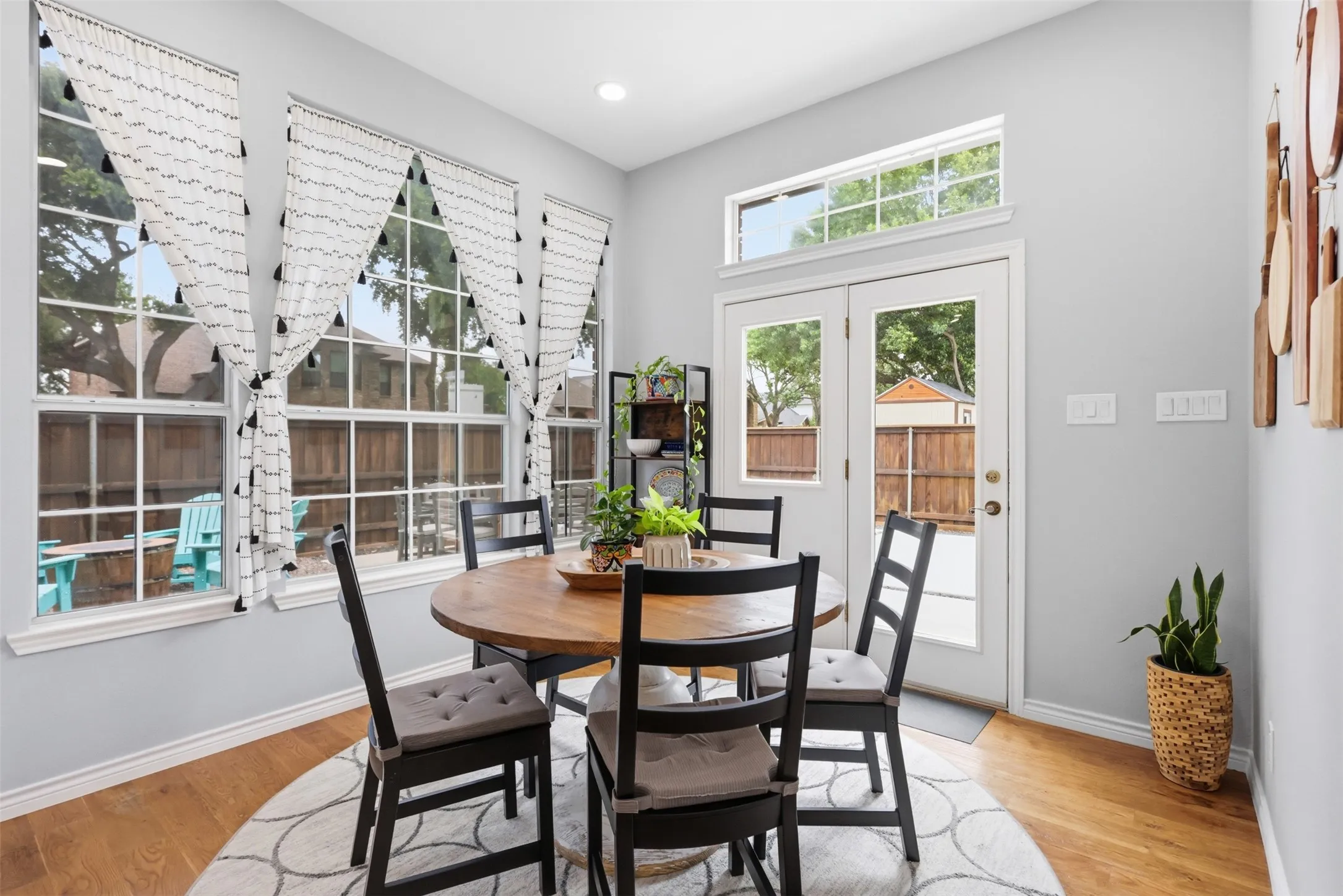 Dining area featuring wood-finish flooring, light gray walls, and white trim