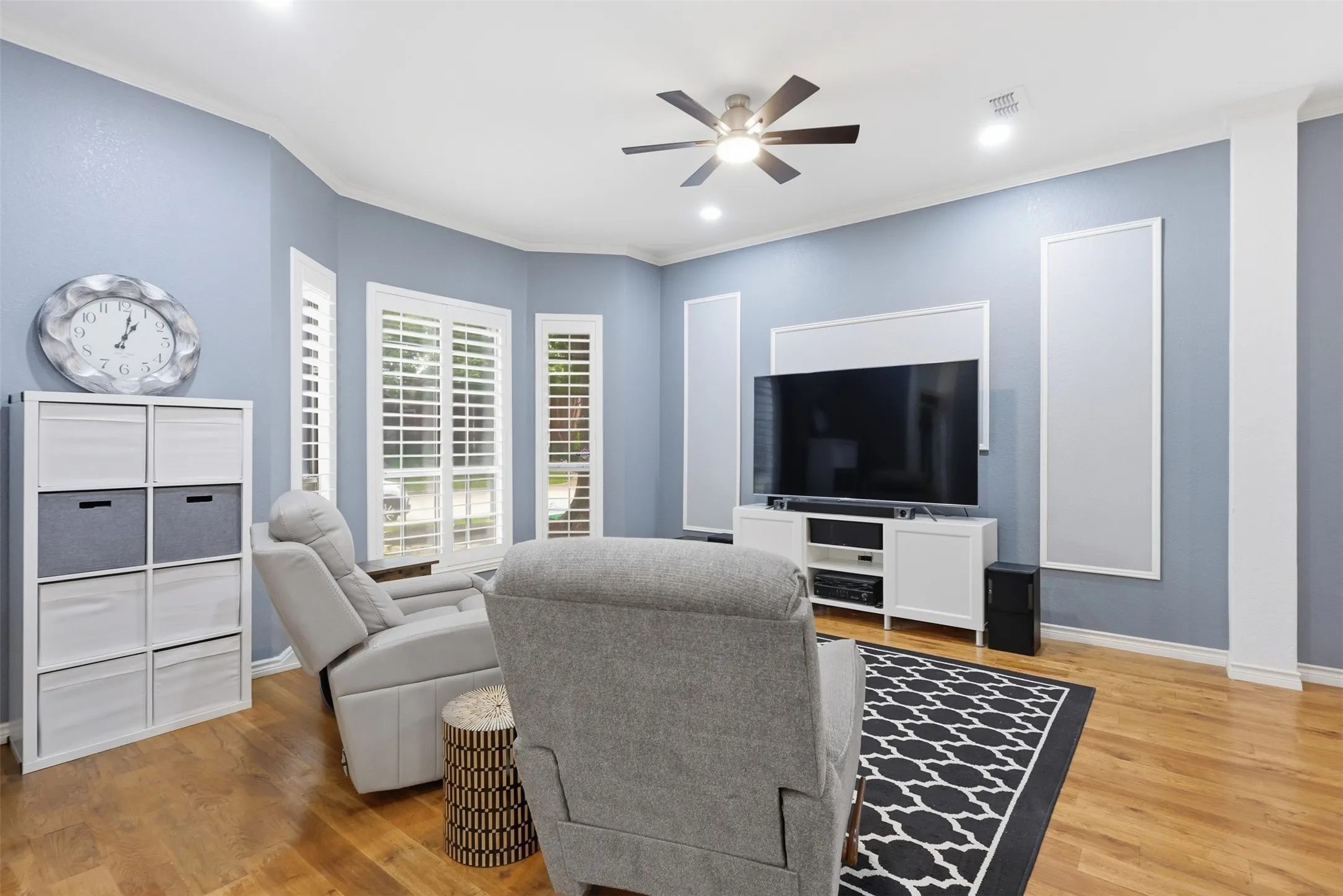 Living area featuring wood-finish flooring and light blue walls