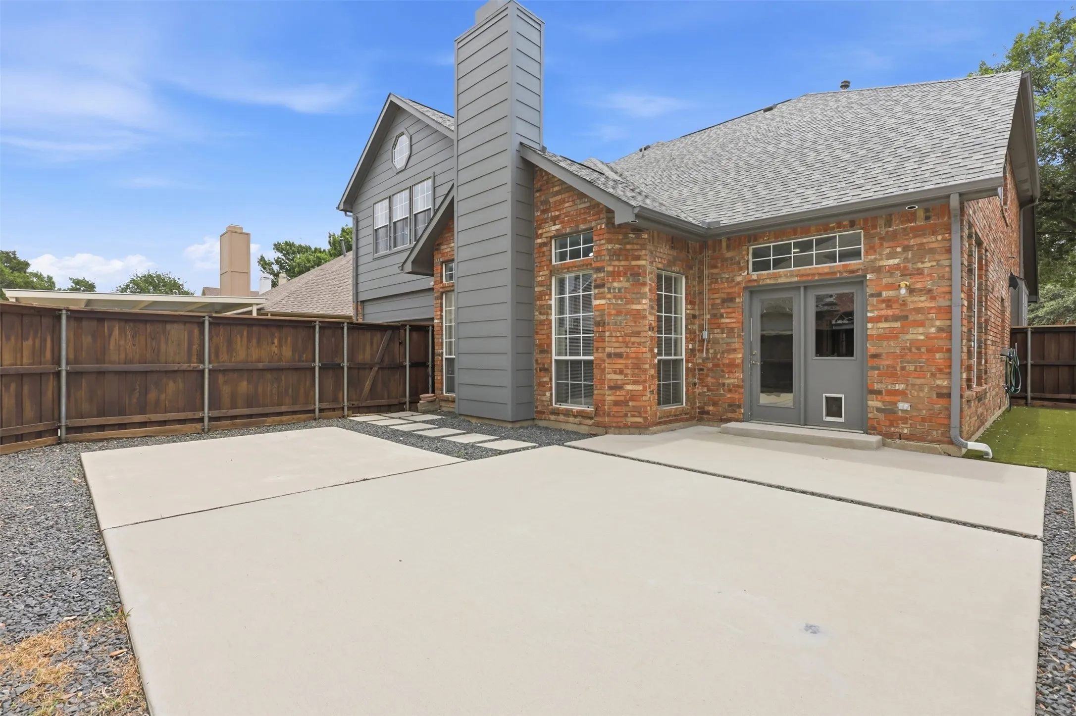 Brick exterior with gray siding and chimney