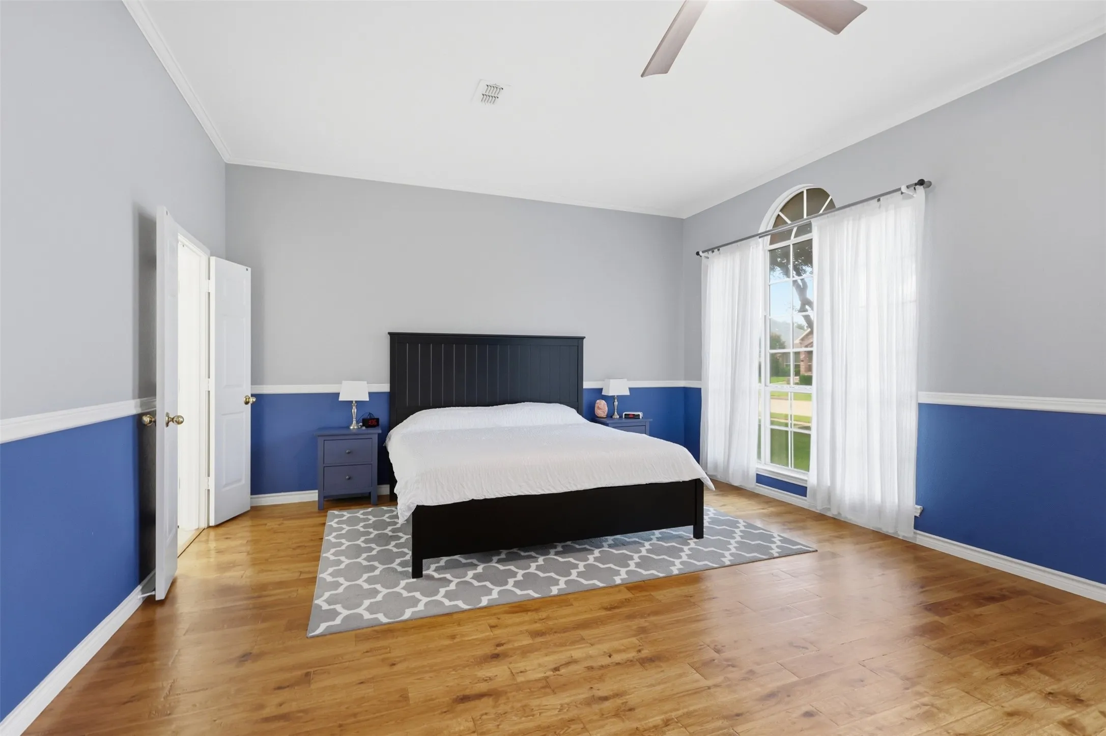 Spacious room with wood-finish flooring and a vaulted ceiling