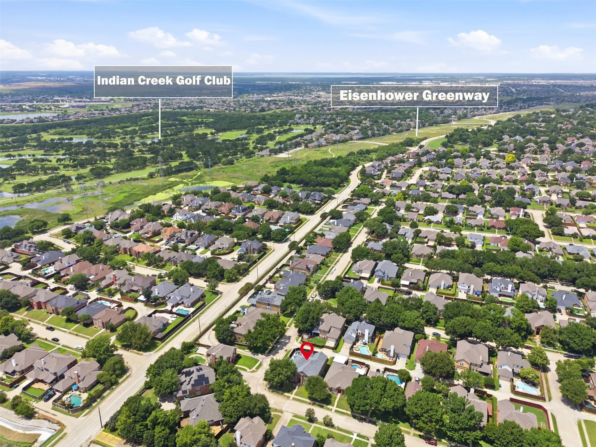 Aerial perspective showcasing a residential neighborhood with Indian Creek Golf Club and Eisenhower Greenway in the distance