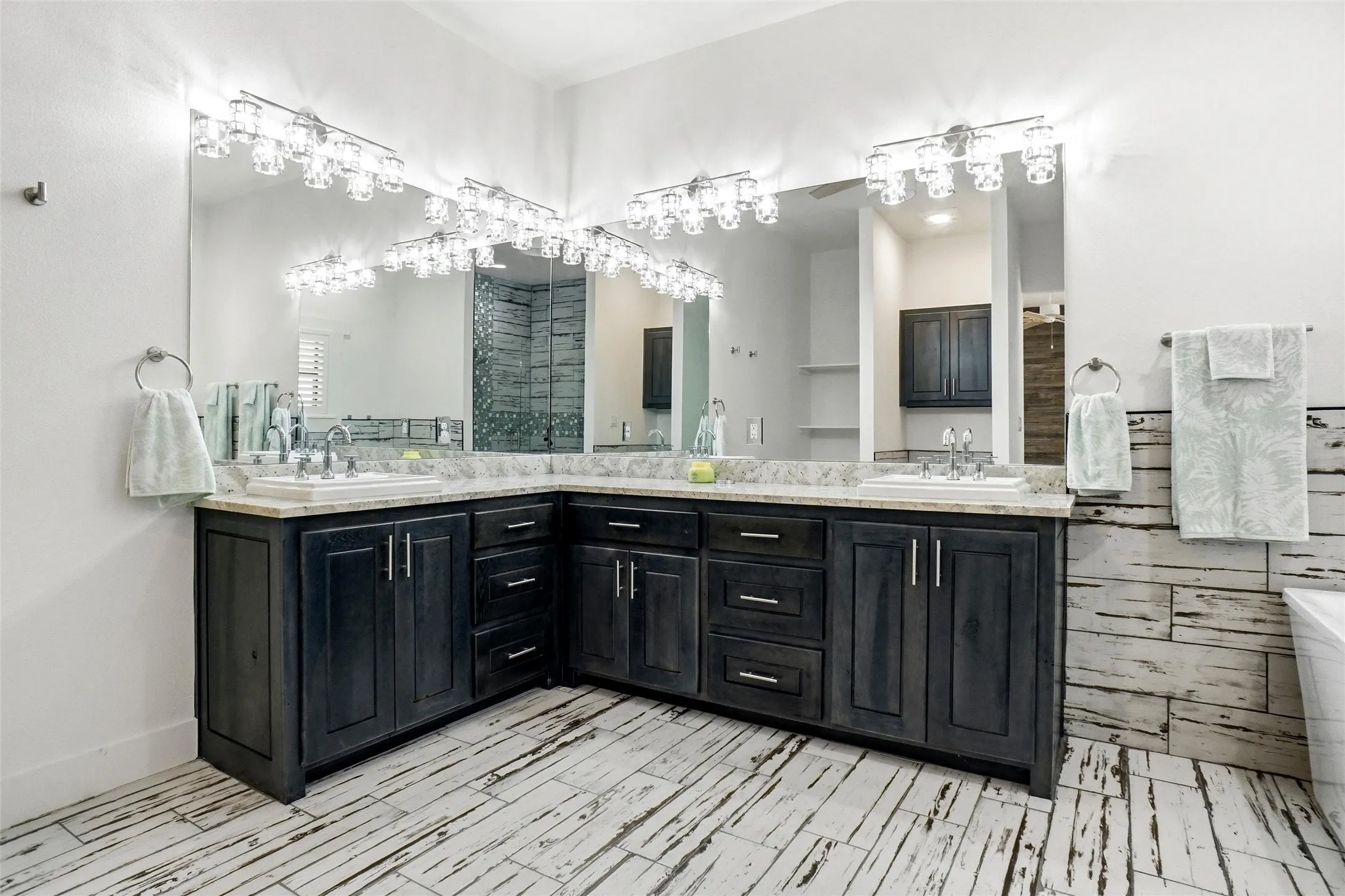 Vanity area in primary bath; soaking tub is to the right of the photo.