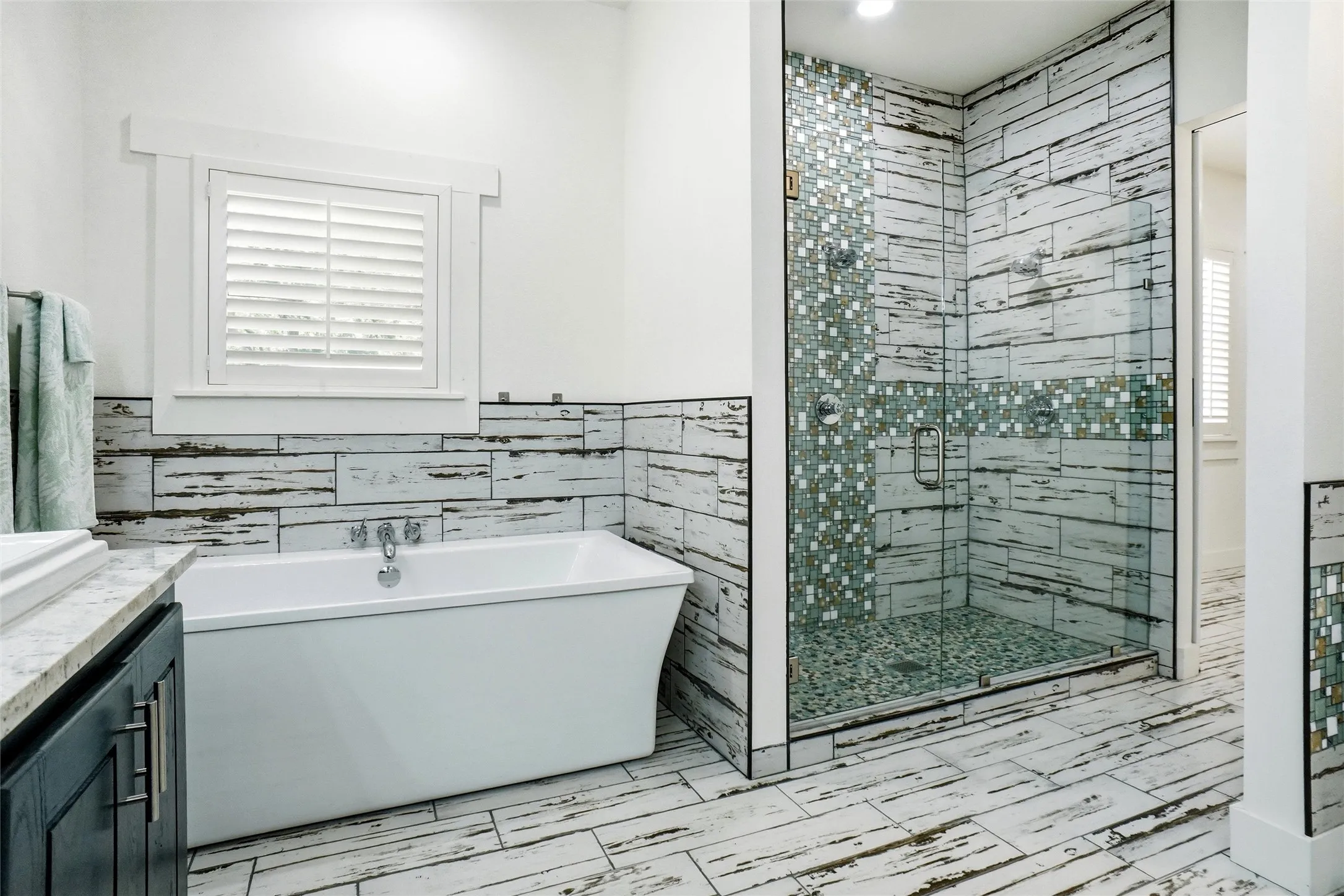 Soaking tub in primary bath, with large beautifully tiled shower.