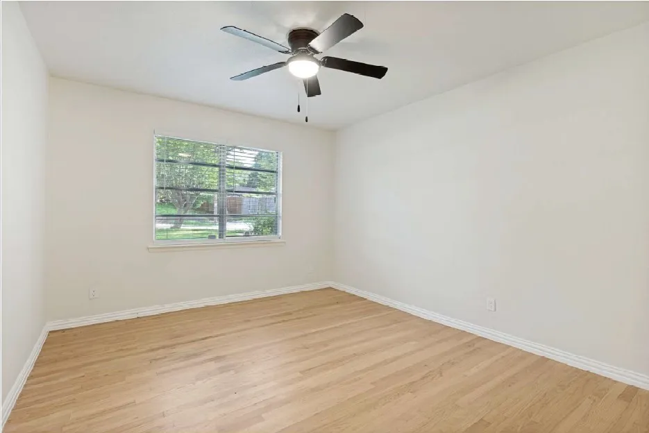 2nd Bedroom featuring wood-finish flooring, a ceiling fan with integrated lighting, a window with blinds, and light-colored walls