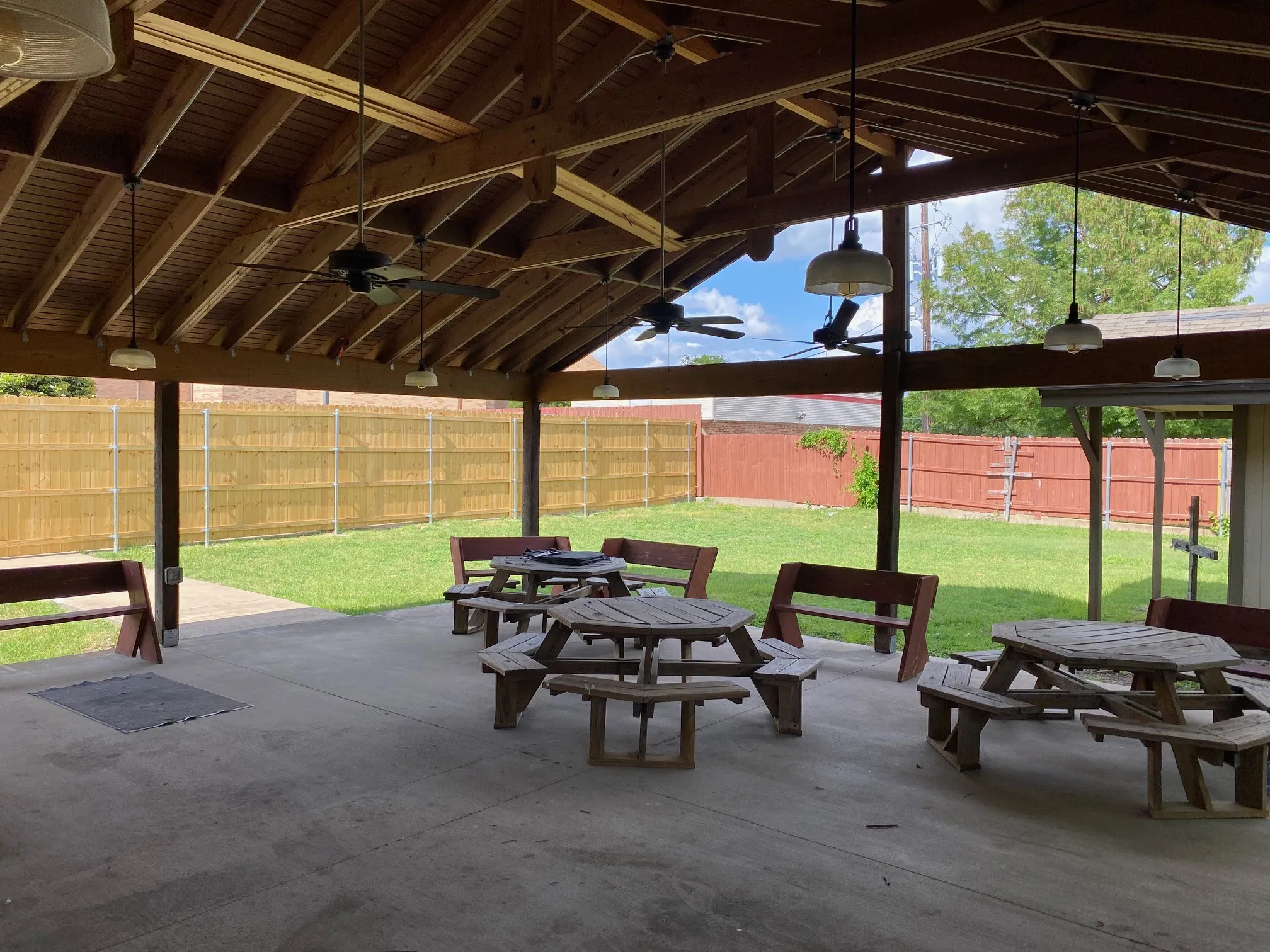 Covered Patio with light, fans, picnic tables and benches.