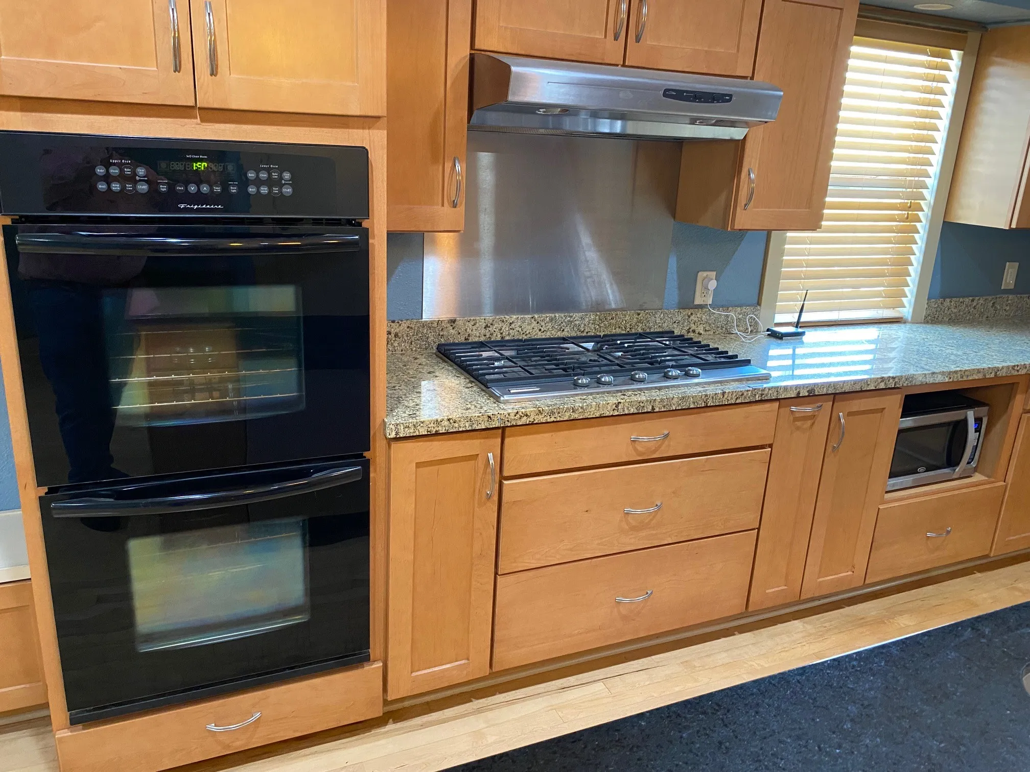 Double ovens and five burner cooktop.