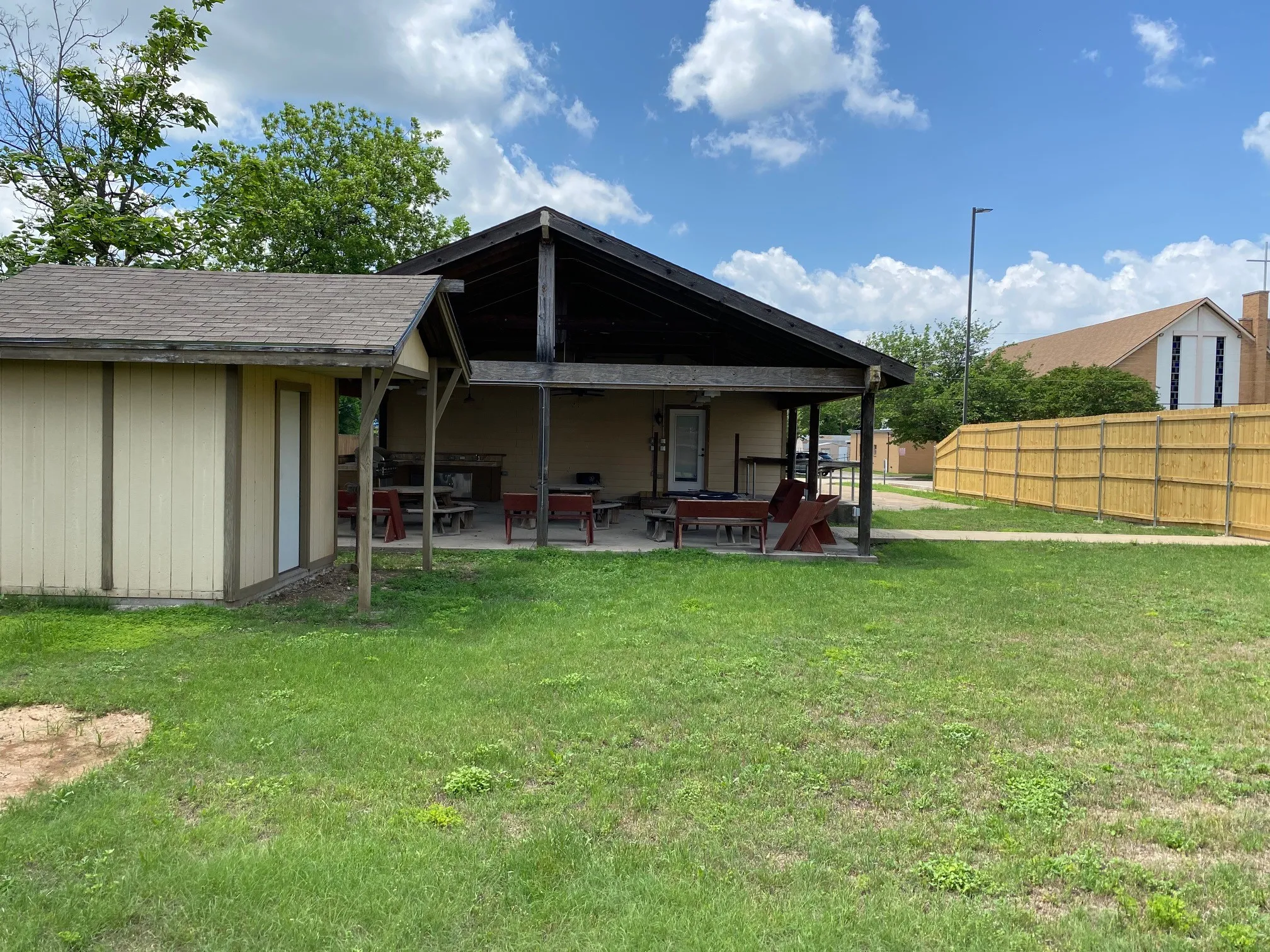 Backyard toward shed and covered patio.