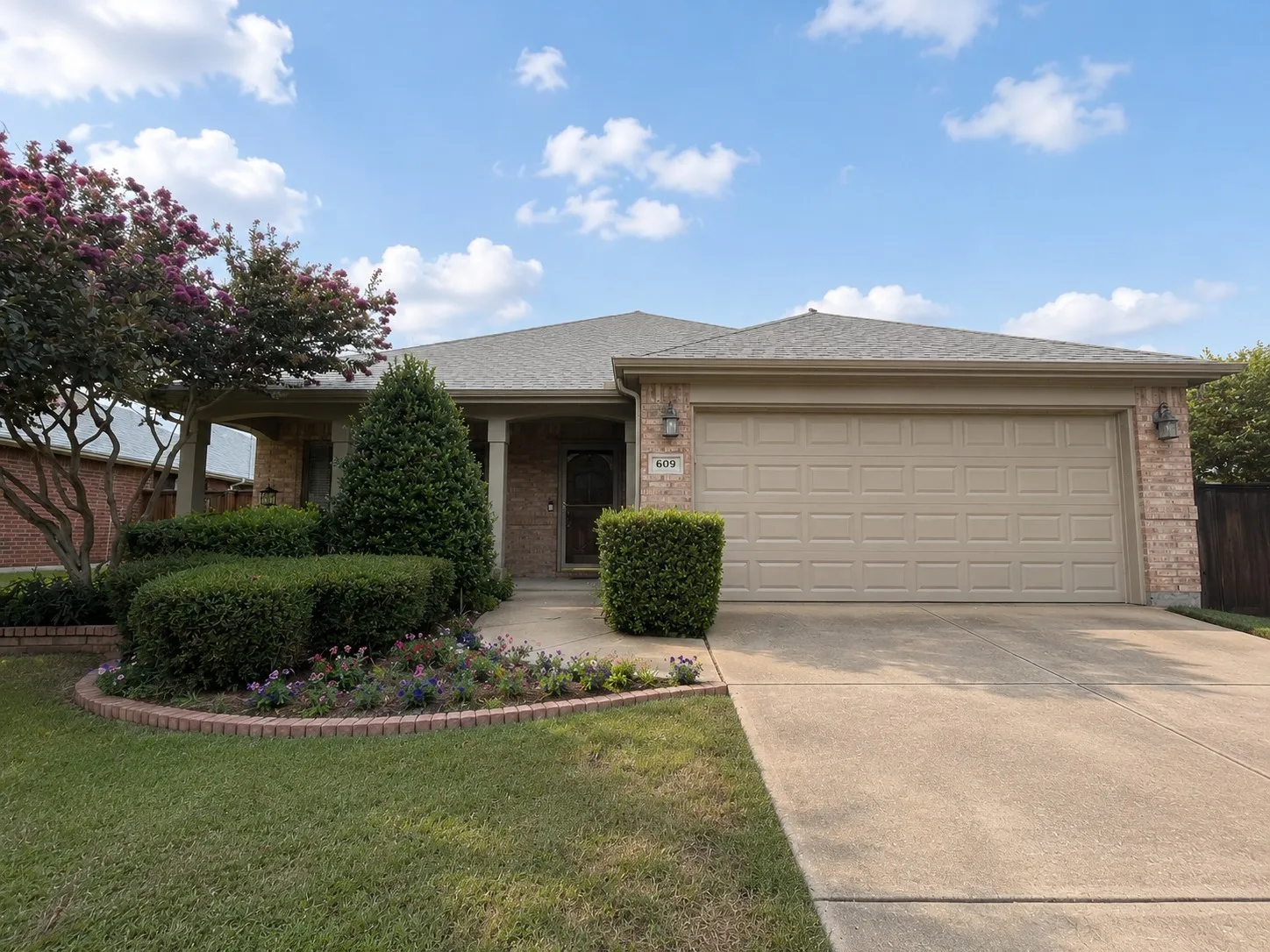 This beautifully landscaped home welcomes you with a spacious front porch complete with a charming swing and a storm door that allows abundant natural light to fill the entry.