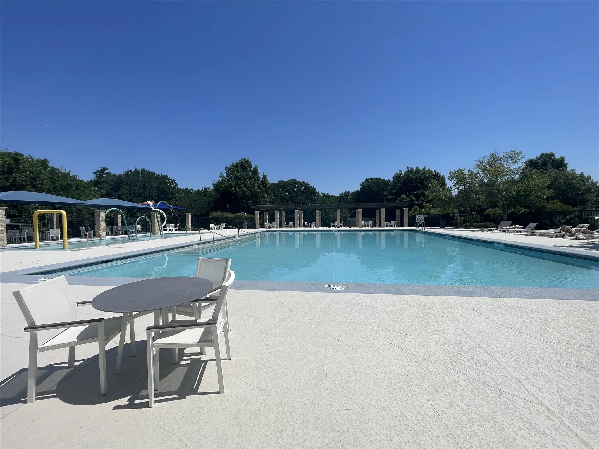 Splash pad, pool & shady places to relax or lounge.