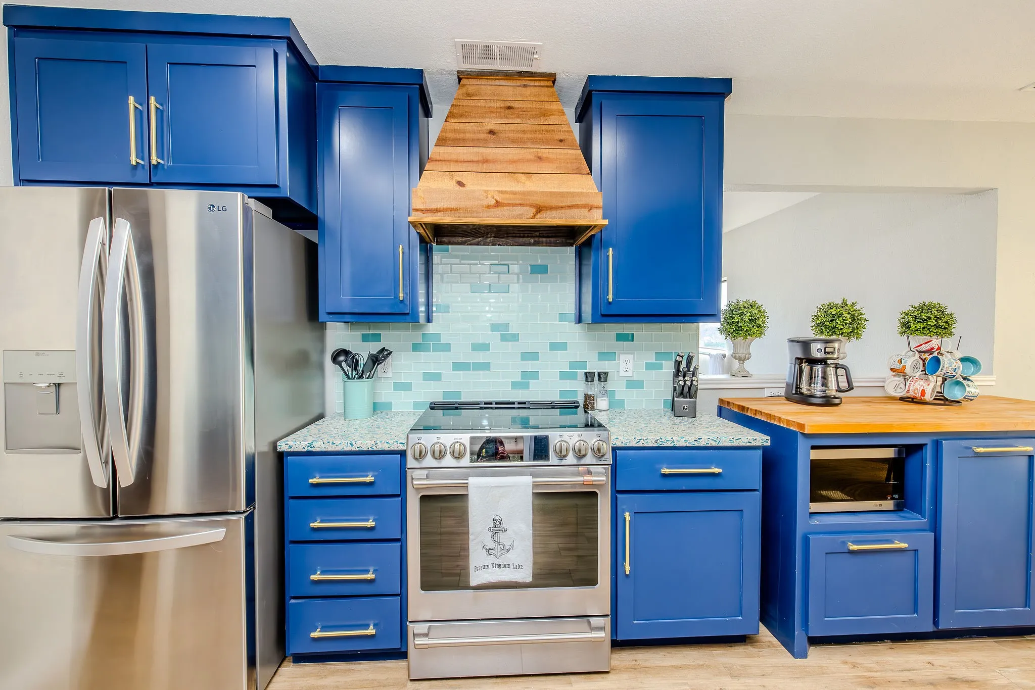 custom cabinets and vent hood with butcher block coffee bar