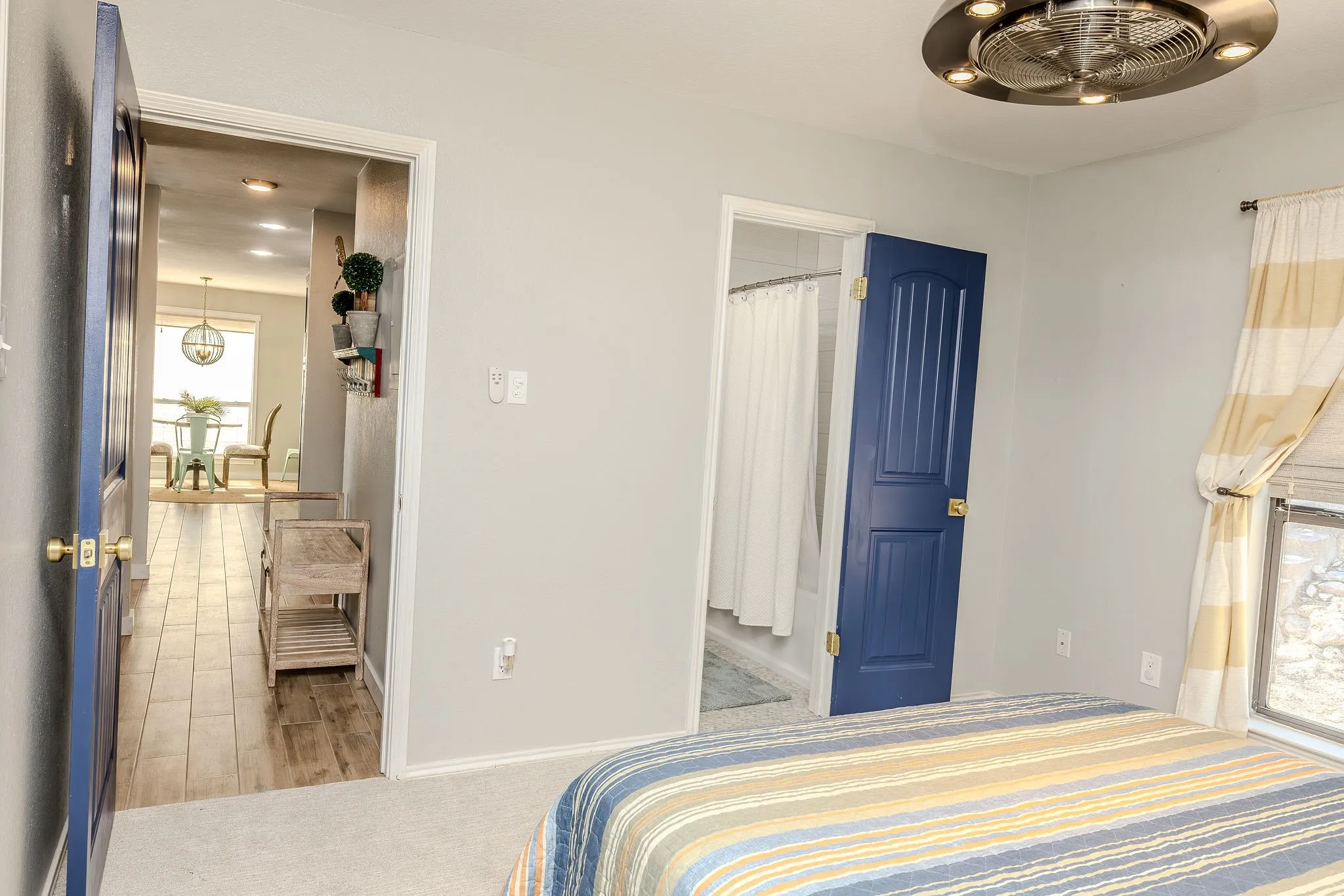 Light gray wall paint complemented by bright white trim and blue panel doors