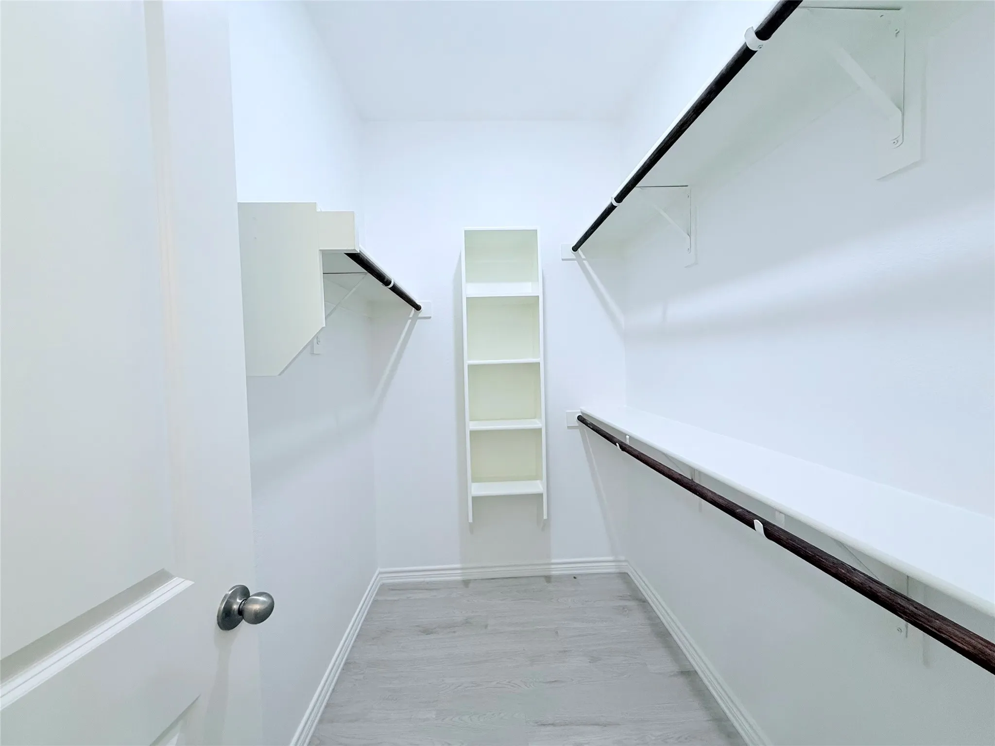 Primary bedroom walk in closet