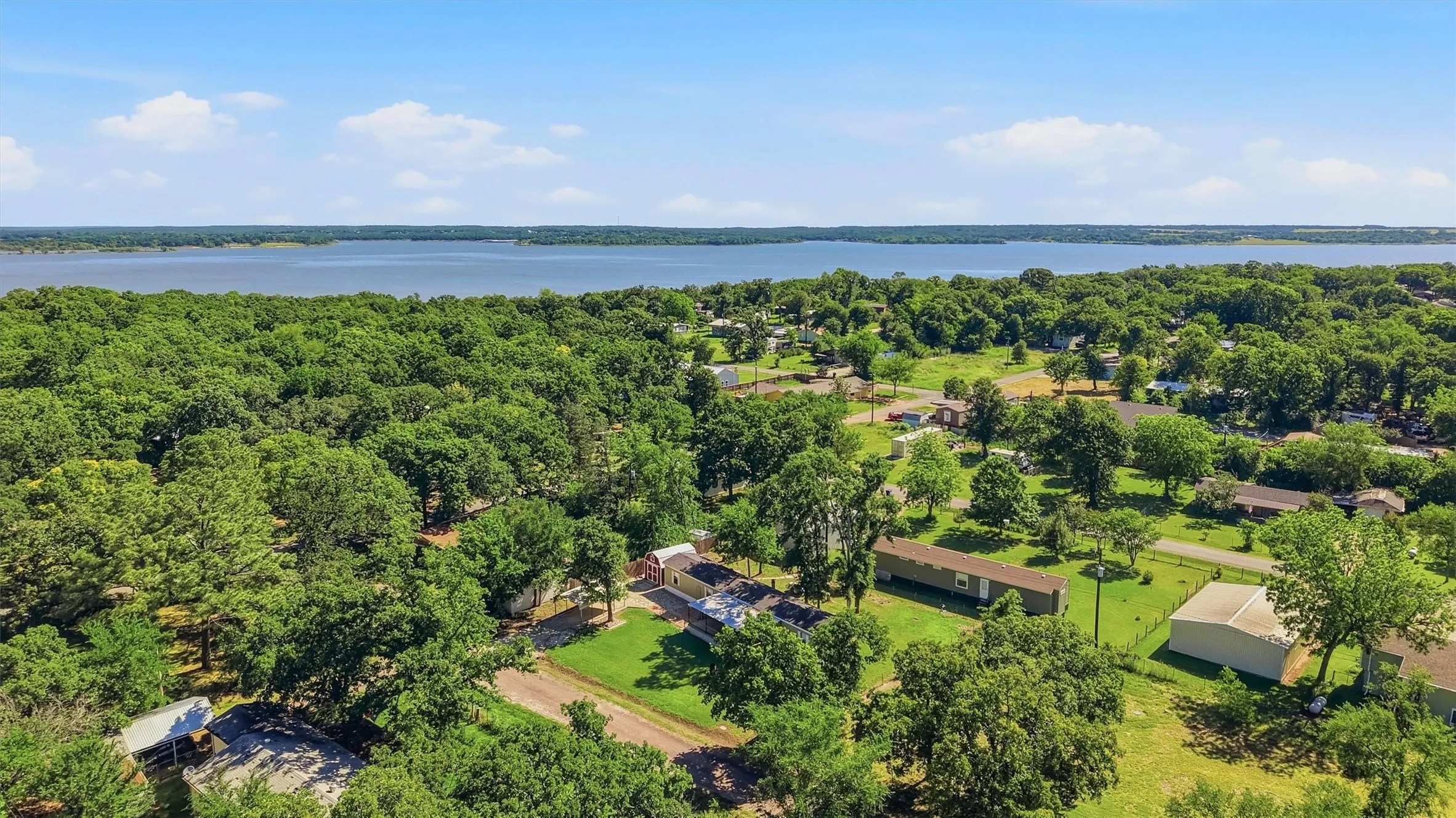 Expansive water body bordering a treed landscape