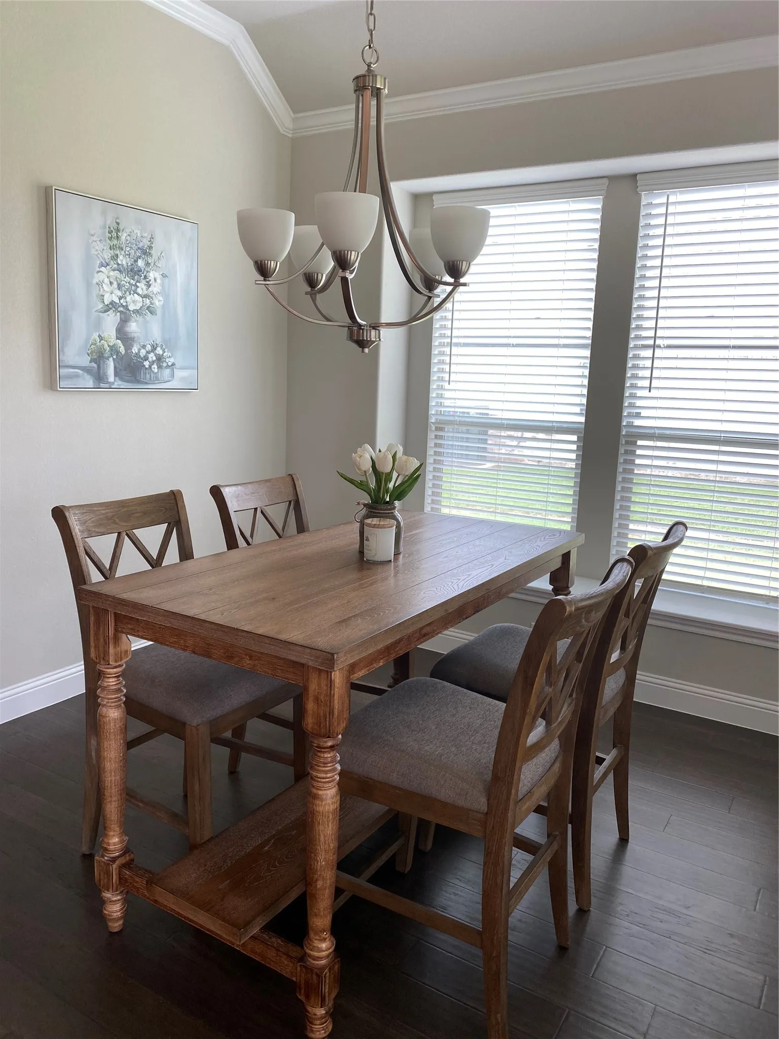 Dining area featuring ornamental molding, a notable chandelier, and dark wood-type flooring