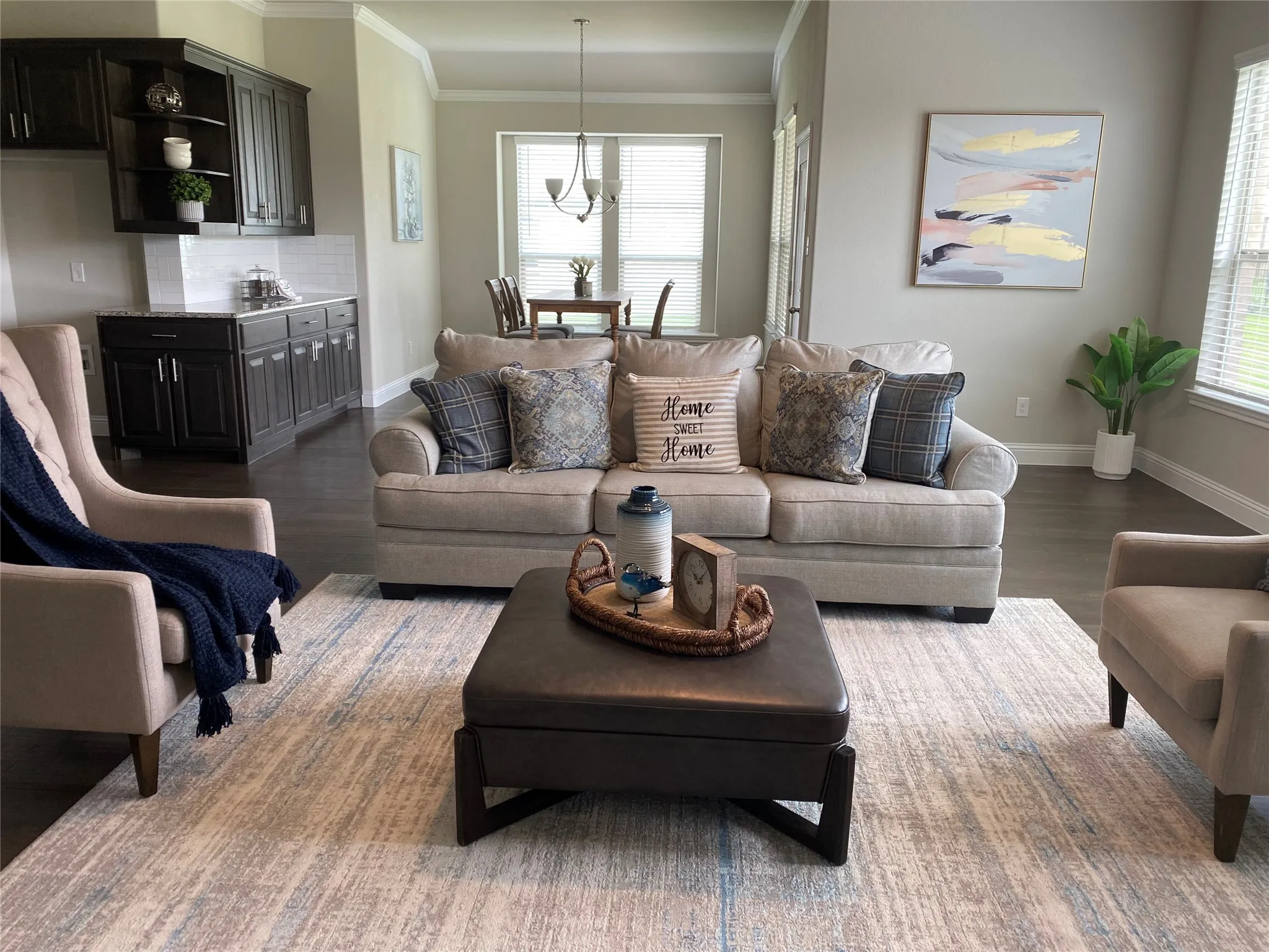 Living room featuring ornamental molding, an inviting chandelier, and dark wood-type flooring