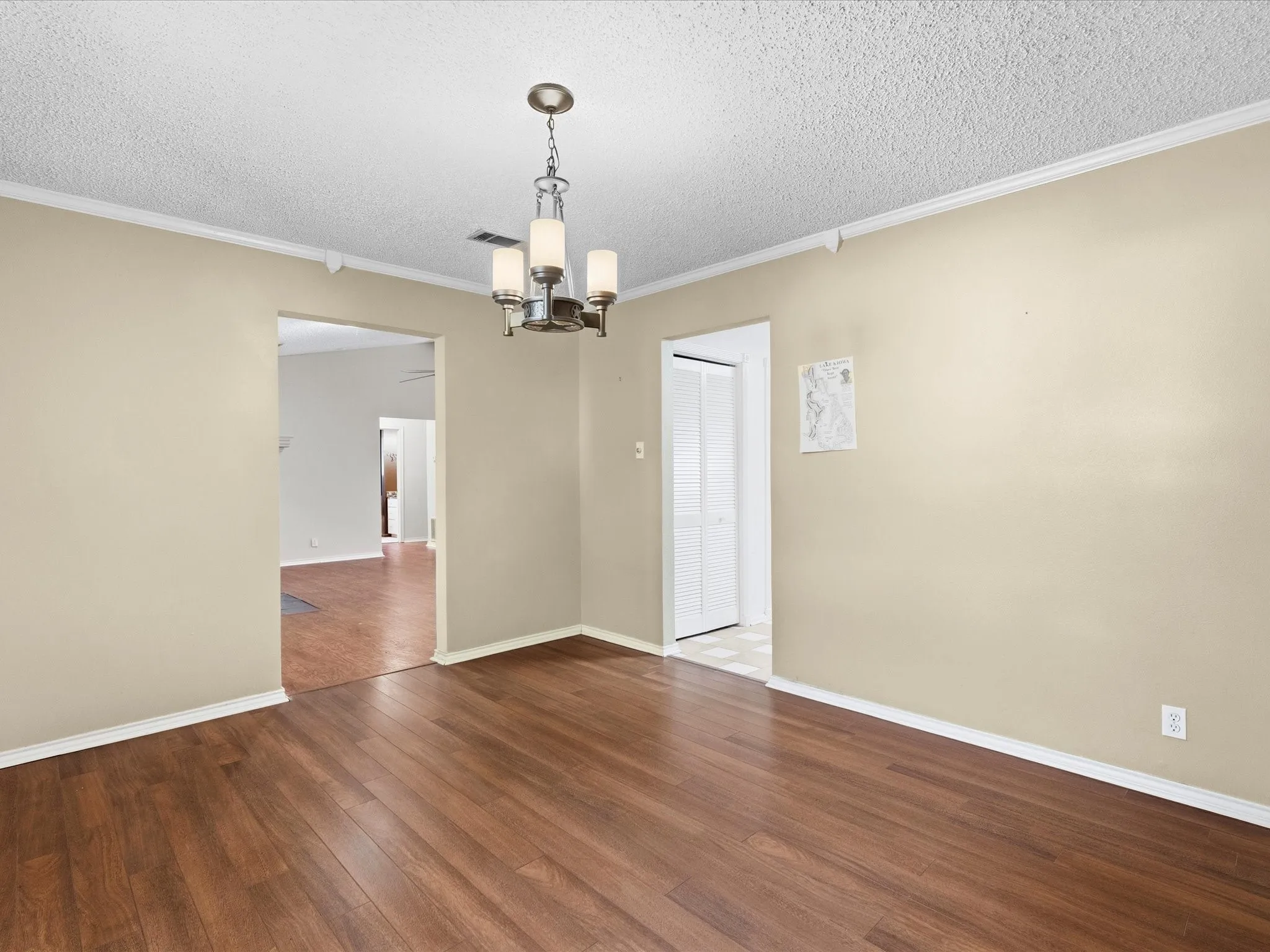 Dining room, warm wood look pergo flooring complements neutral wall tones