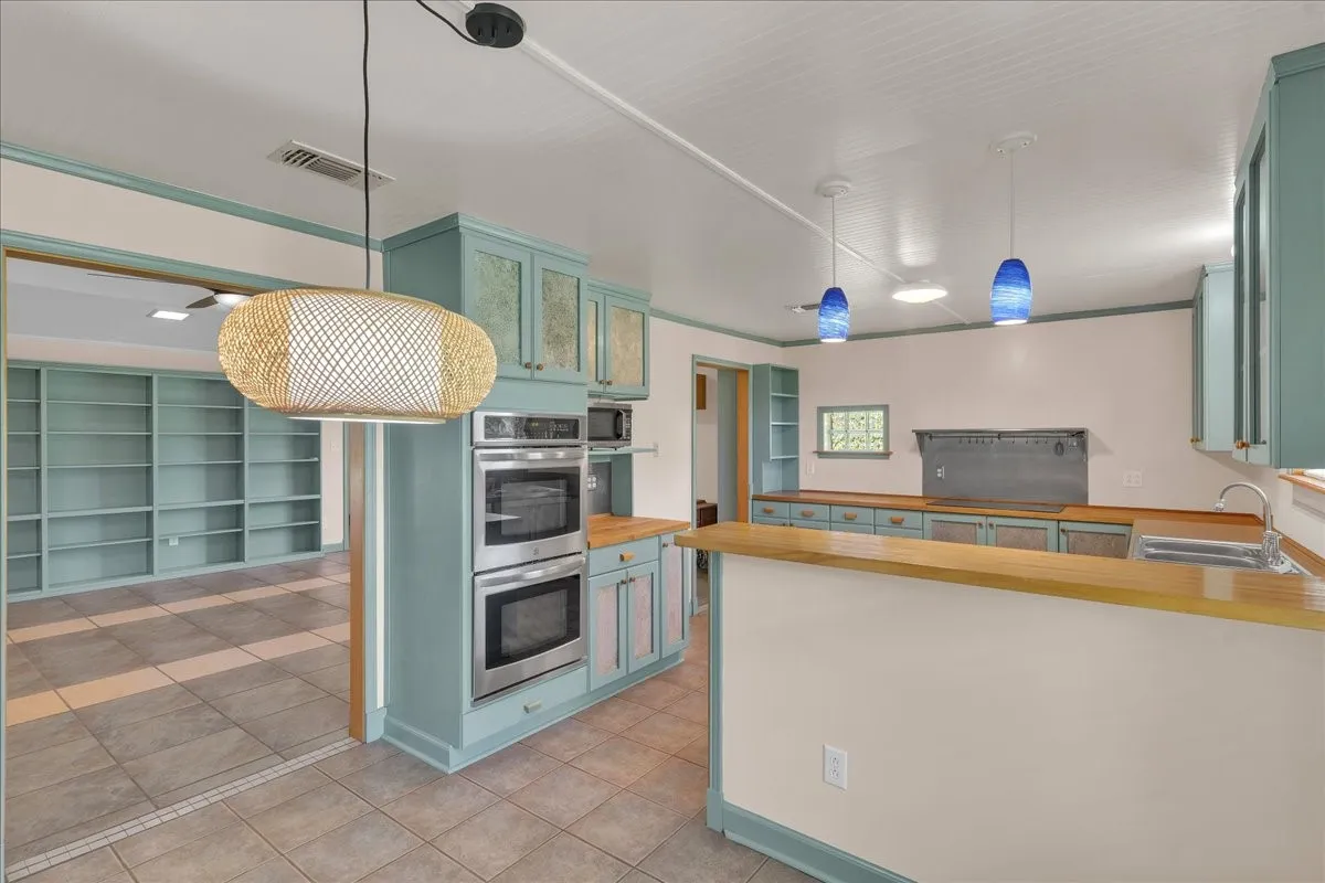 Kitchen features double ovens and stainless steel appliances.
