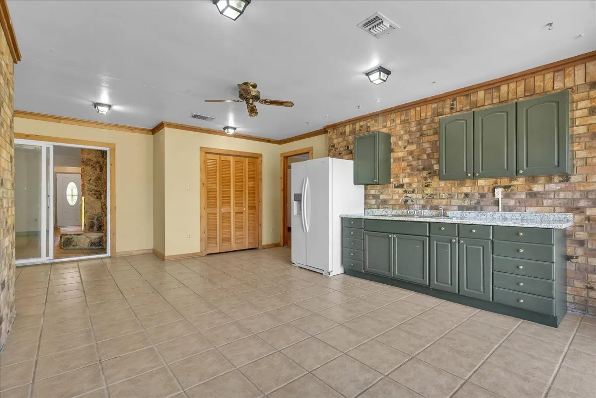 Bonus room or guest suite with a kitchenette and closet.