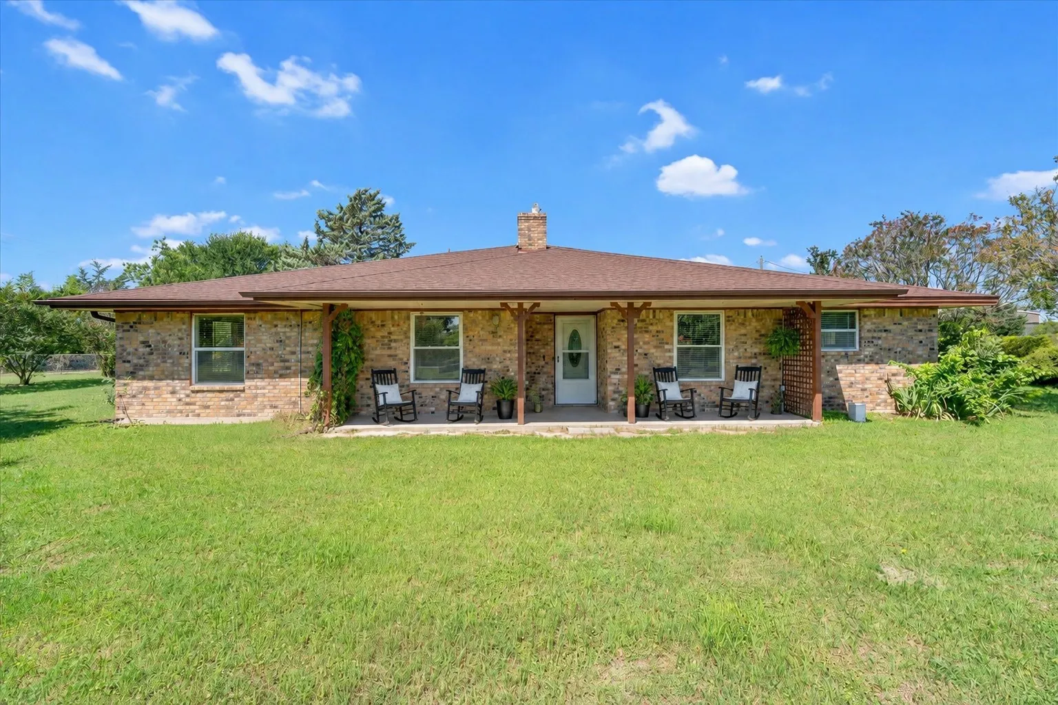 Lovely front photo of the home with large front porch.