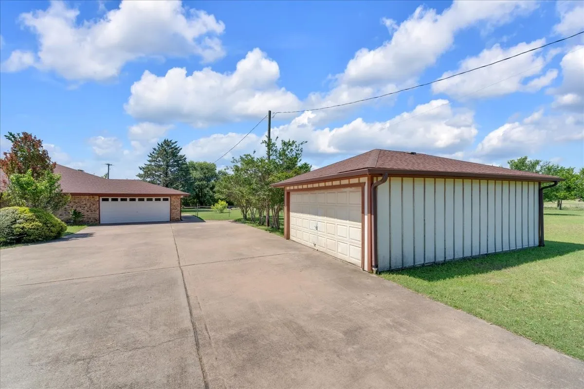 View of the 2-car attached garage and the 2-car detached garage; tons of parking!