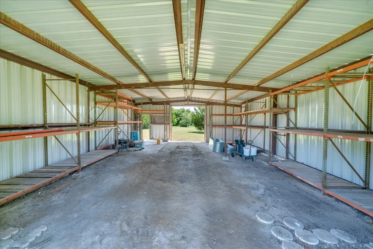 View of the inside of the barn; so much potential for whatever you need! The shelving will stay.
