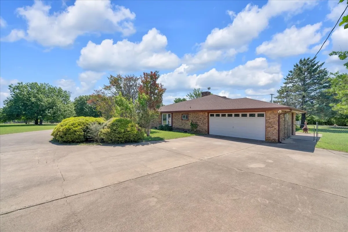 View of the garage-side of the home. Plenty of space for additional vehicles.