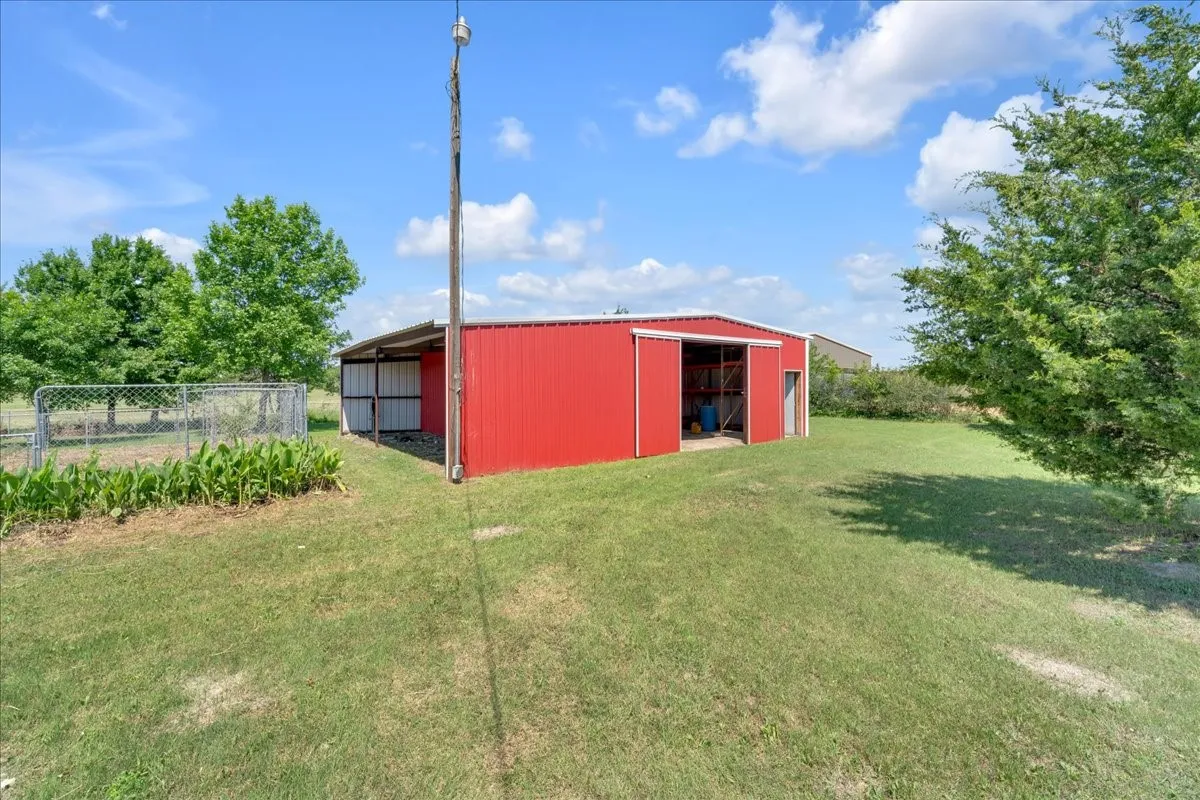 Huge 30x40 barn with two rollup doors and a walk-in door. Notice the overhang for additional storage.