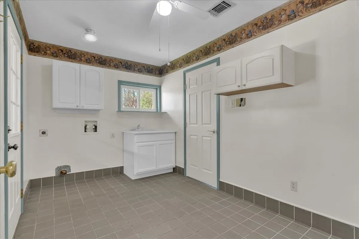 Laundry room with utility sink and plenty of room for a refrigerator and freezer!
