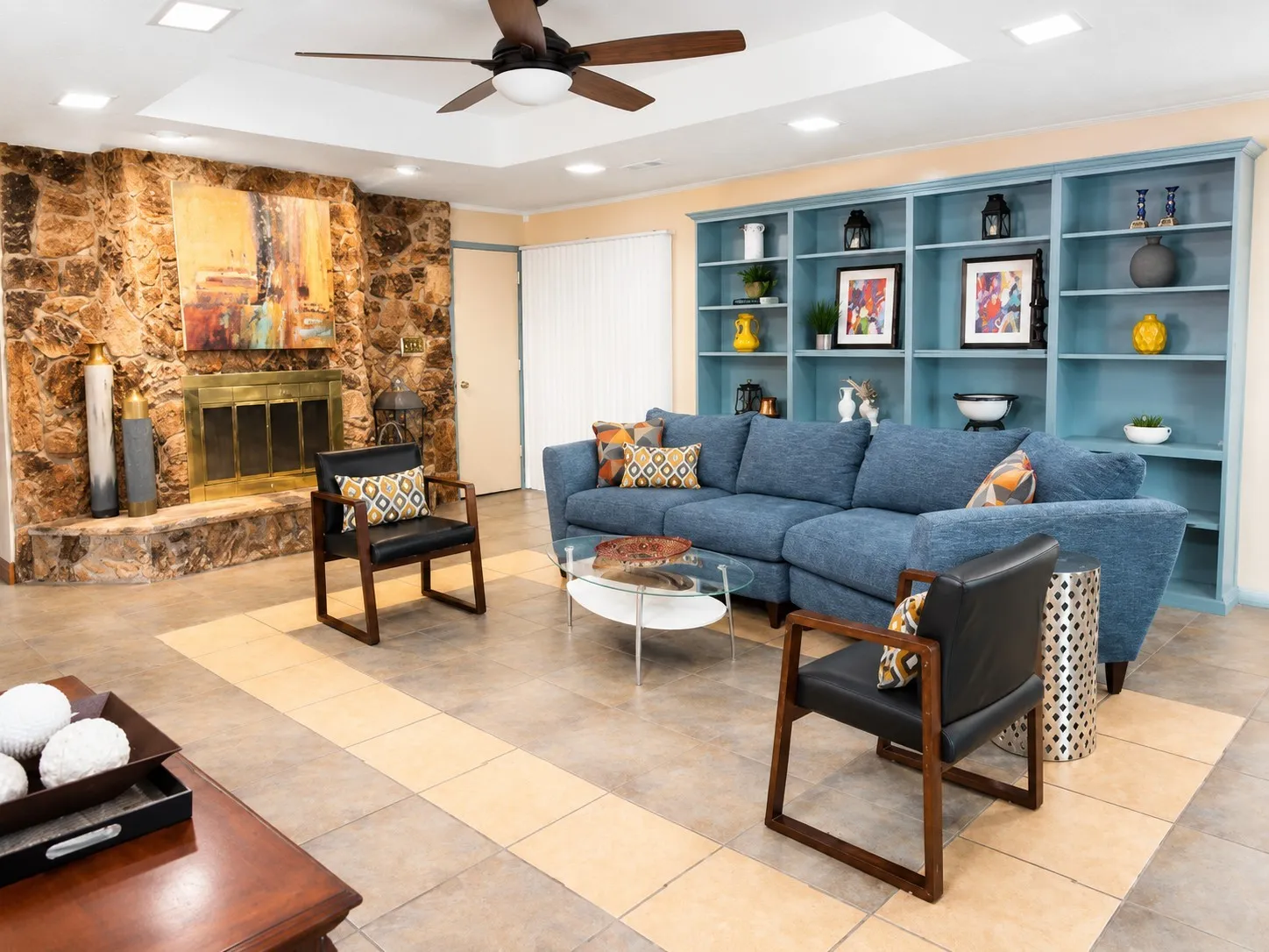 Spacious living room featuring the gorgeous stone fireplace and built-in bookshelves.