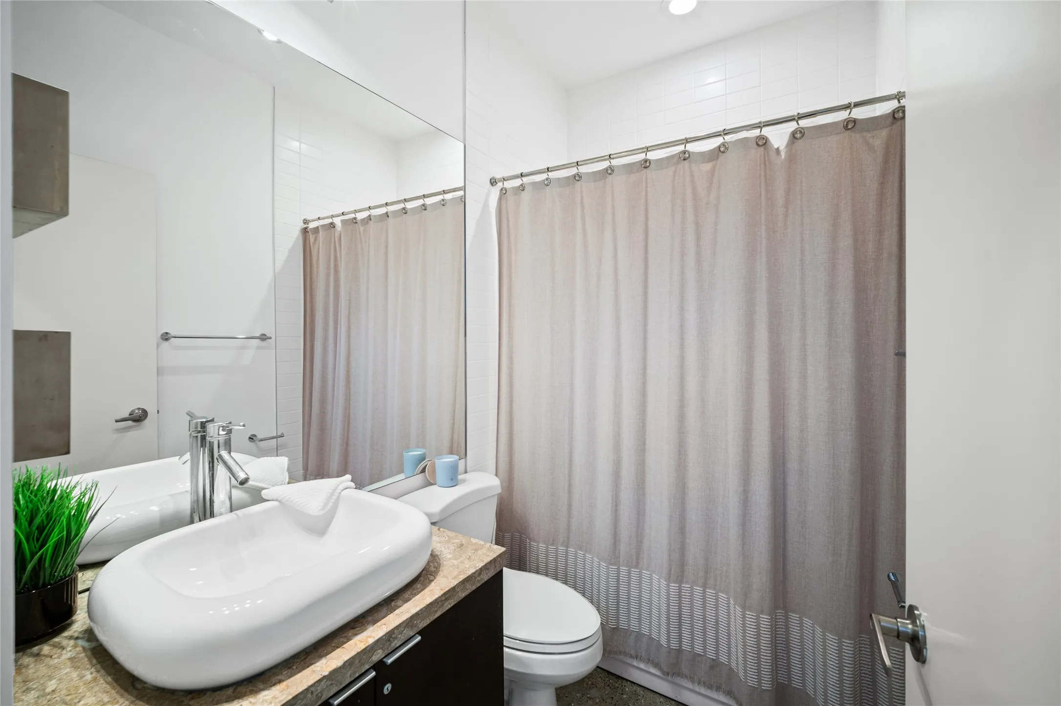 Bathroom featuring a vessel sink, single-lever faucet, and vanity with dark wood-finish cabinetry