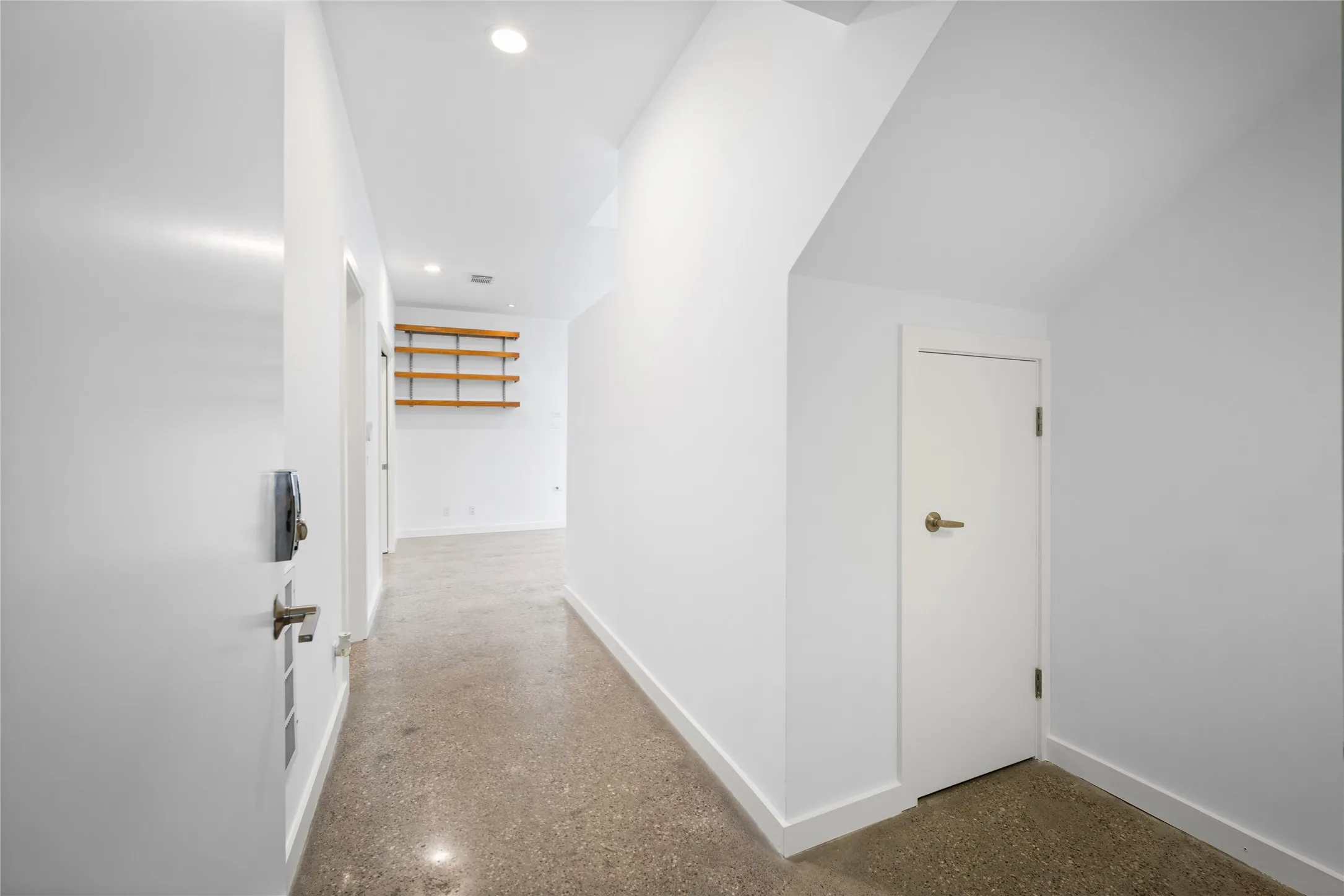Entryway featuring polished concrete flooring, recessed lighting, white walls, and a digital door lock