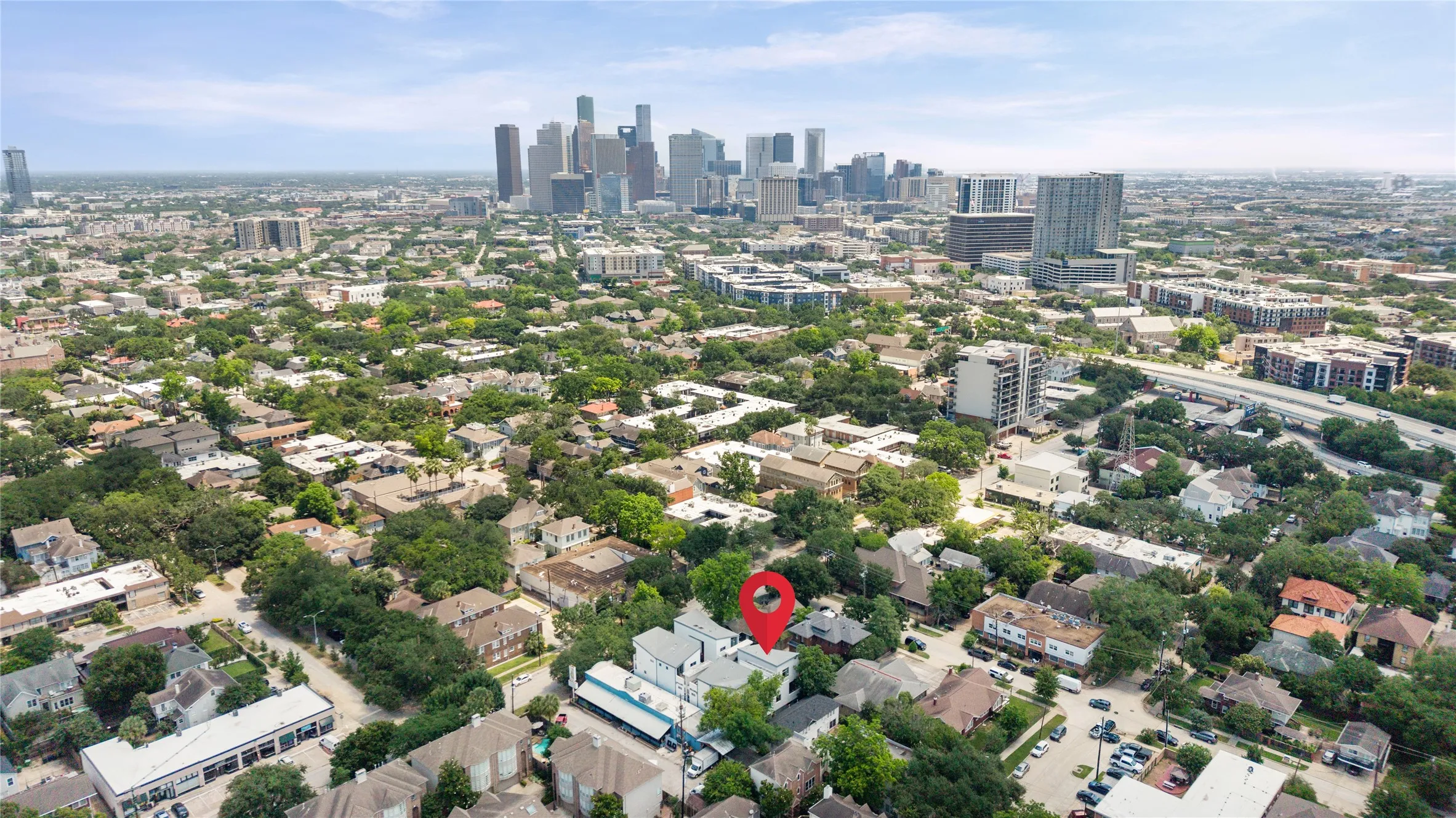 Urban neighborhood setting featuring a vibrant tree canopy and established residential architecture