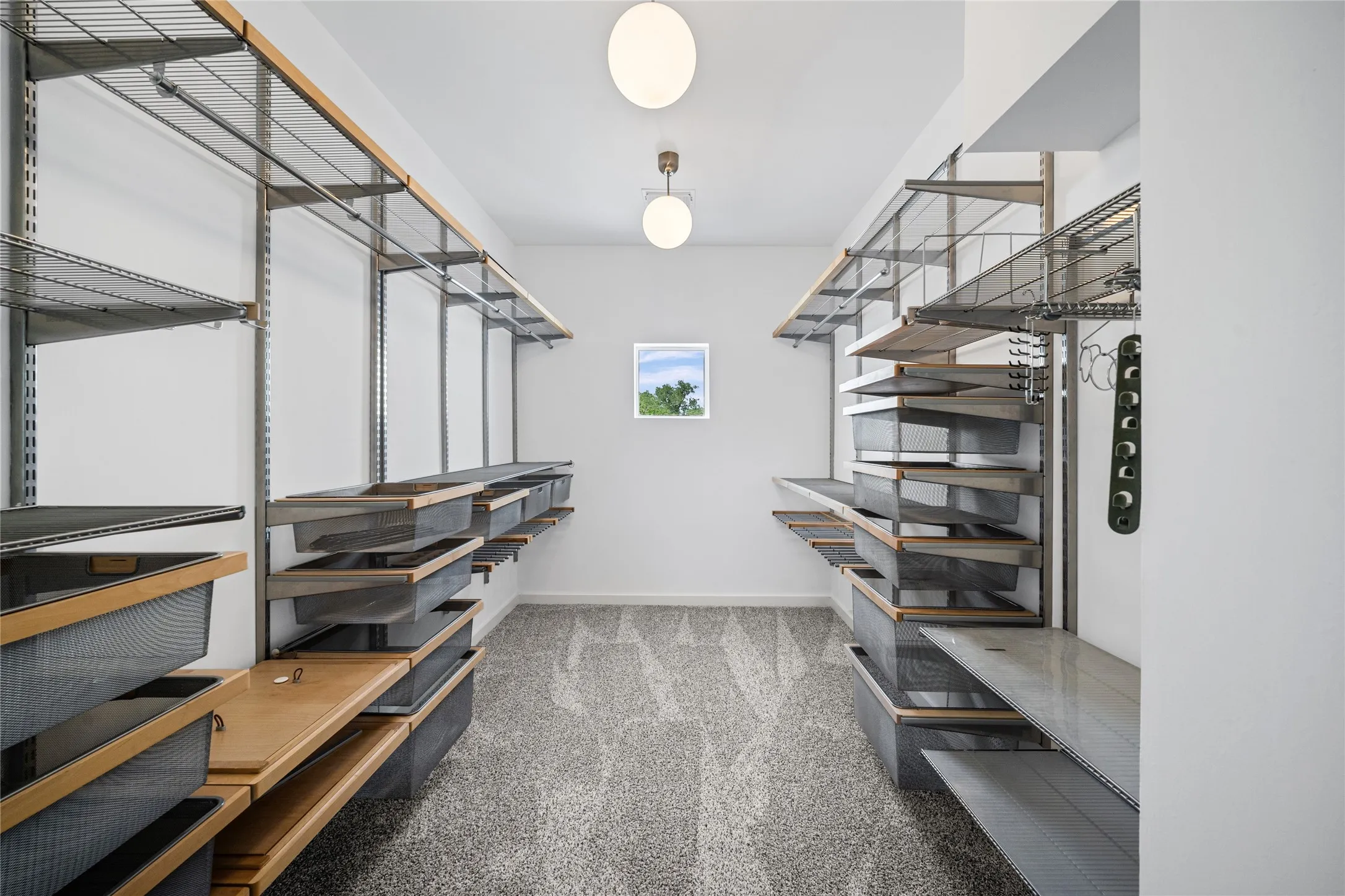 Walk-in closet featuring extensive built-in custom shelving, hanging rods, and wire mesh drawers