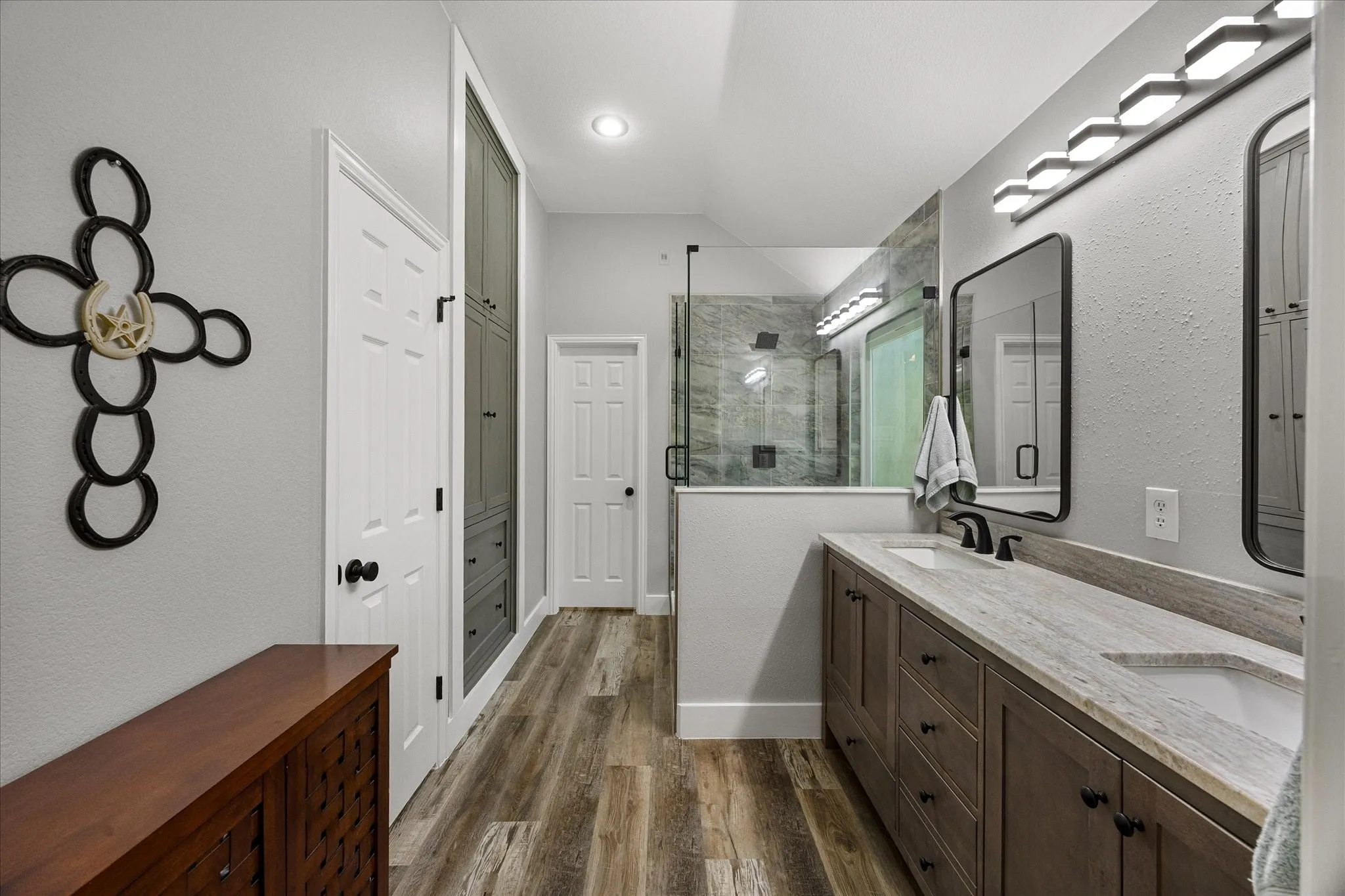 There's also a large walk-in closet and custom built-in linen cabinet with drawers.