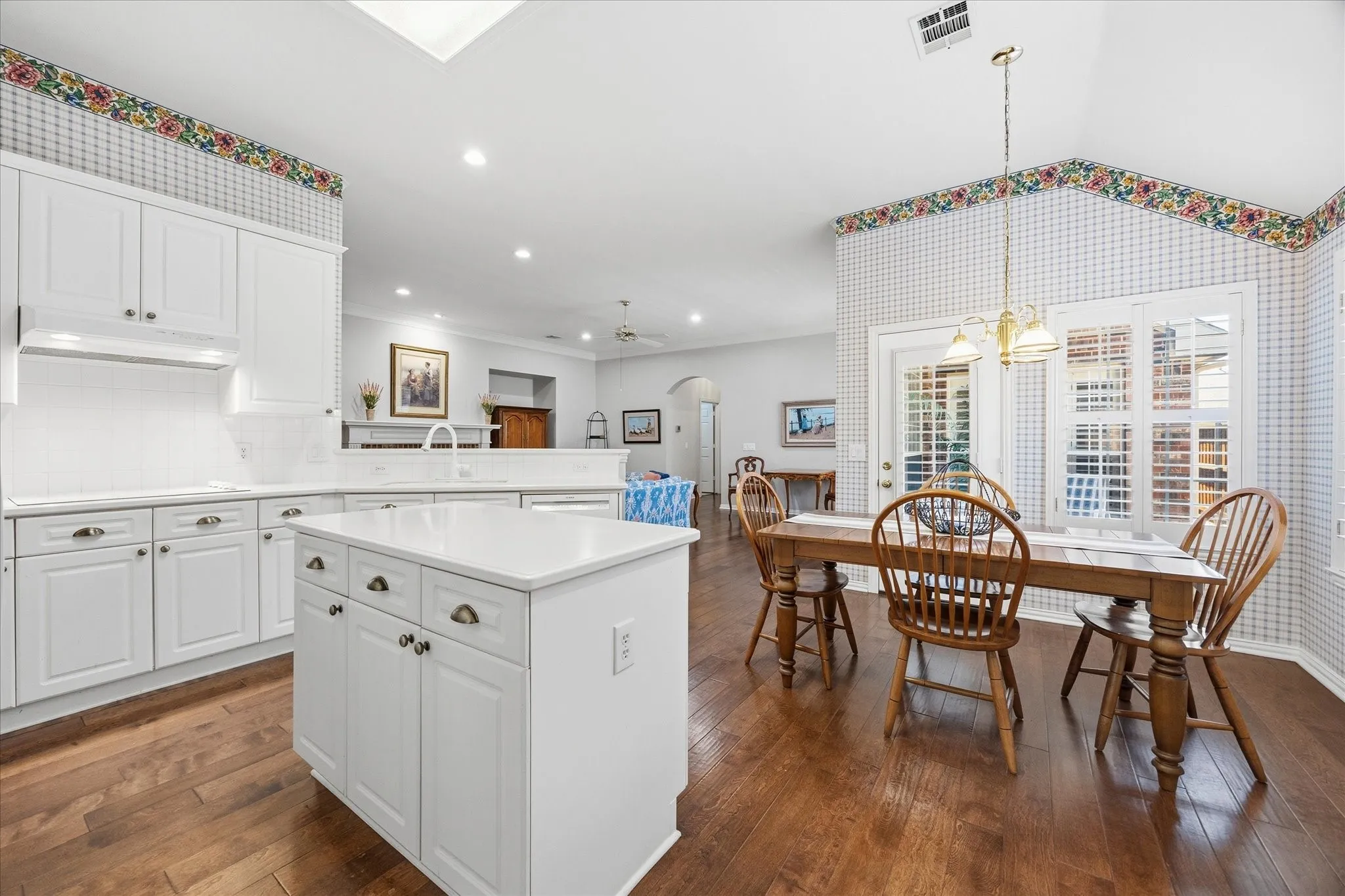 The island kitchen is open to the family and breakfast rooms, keeping you connected as you whip up culinary delights.