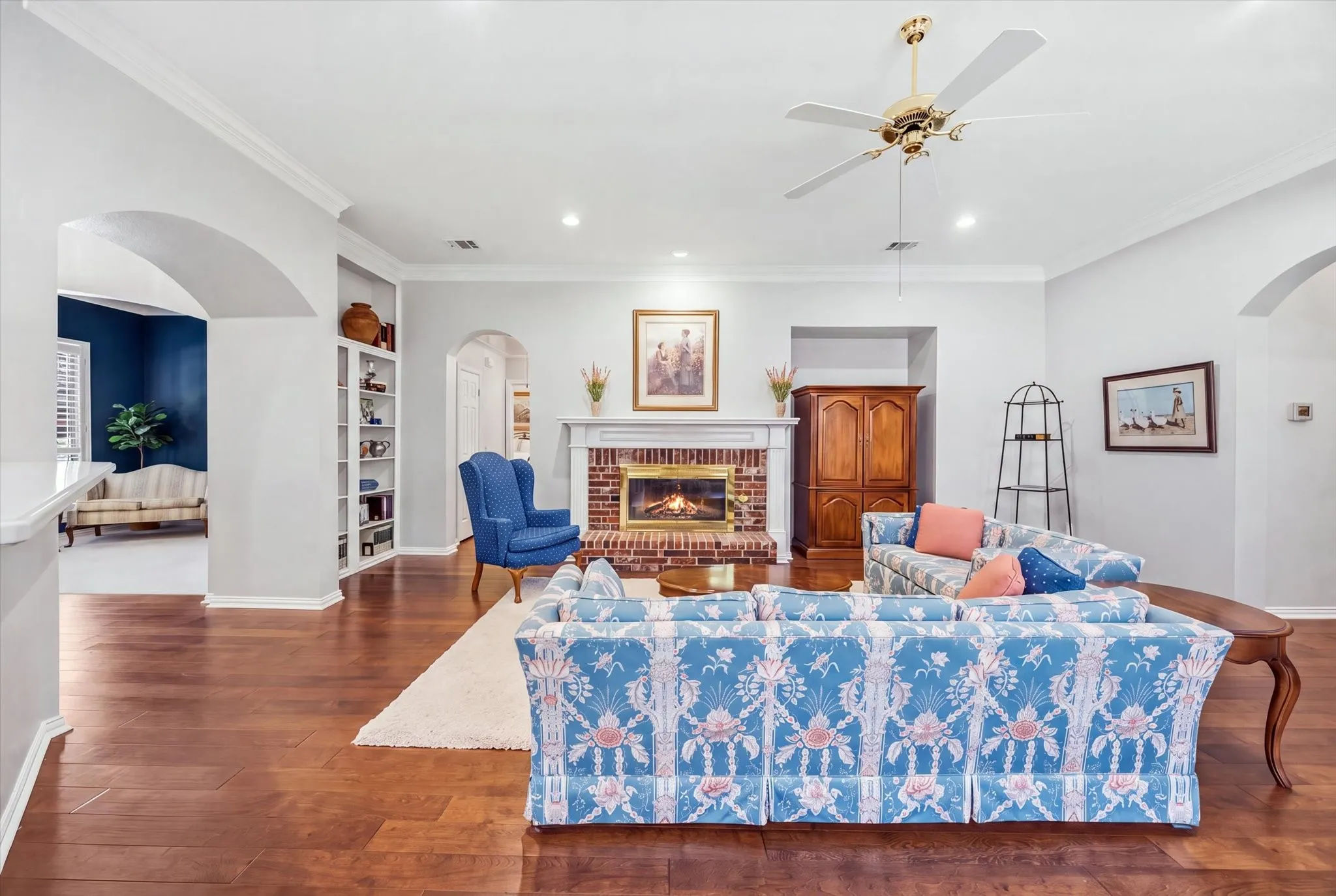 The warm and inviting family room is the heart of the home with its cozy gas-log fireplace and built-in bookshelves.