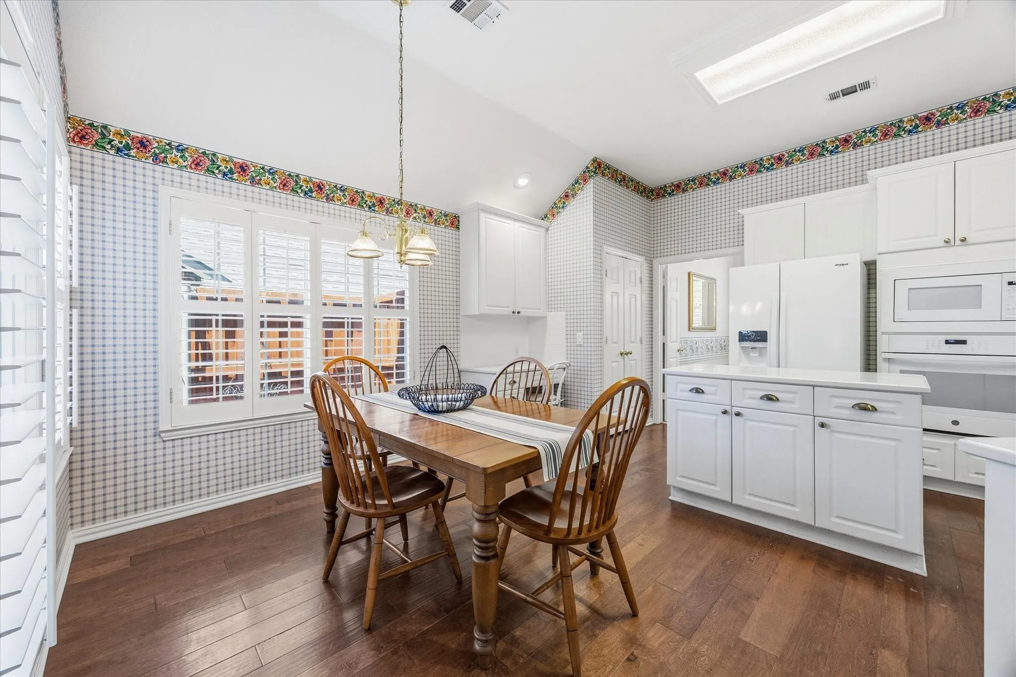 The sunny breakfast room has a door leading to the covered patio.