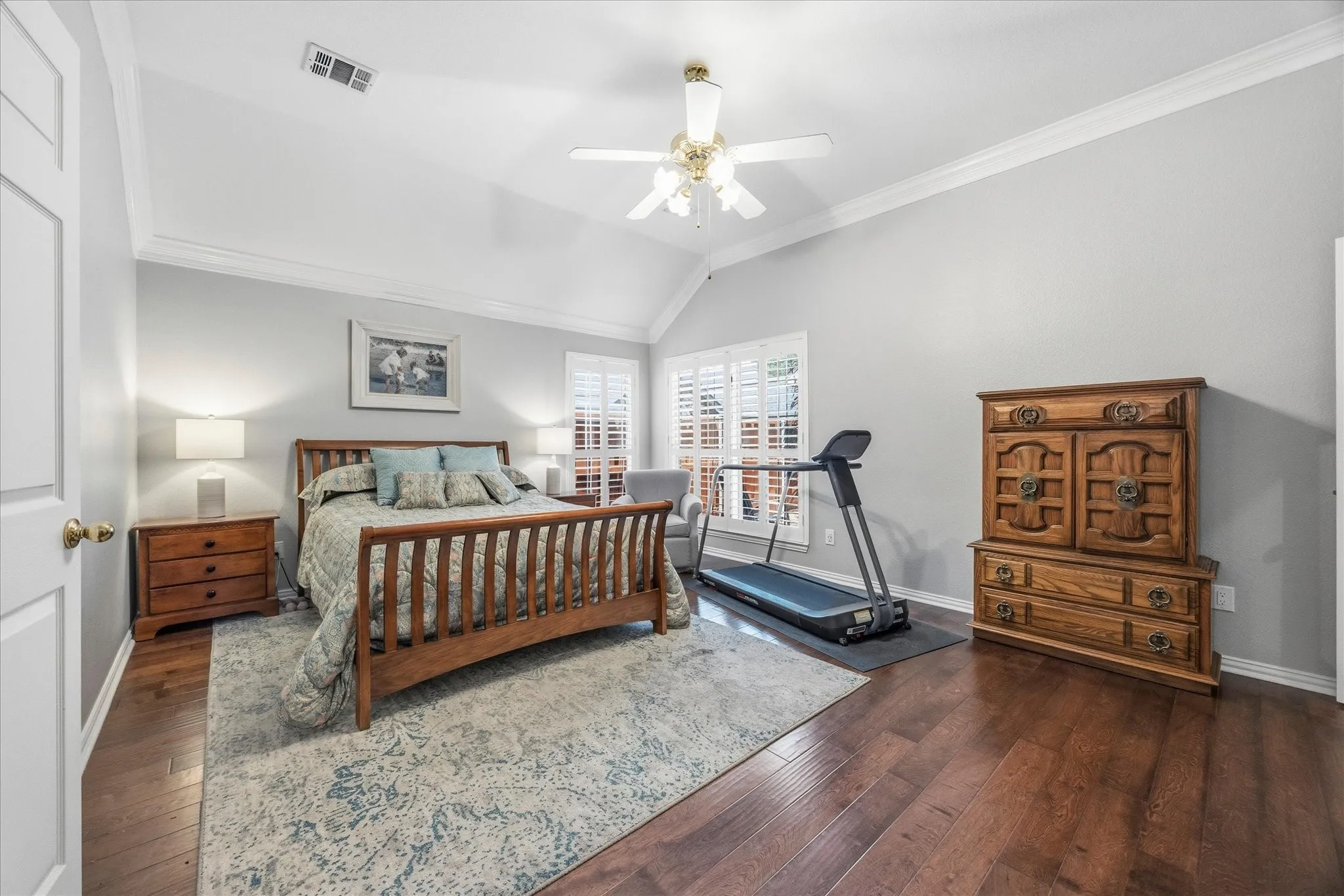 This tranquil space features gorgeous hardwood flooring and high ceiling, accented with crown molding.