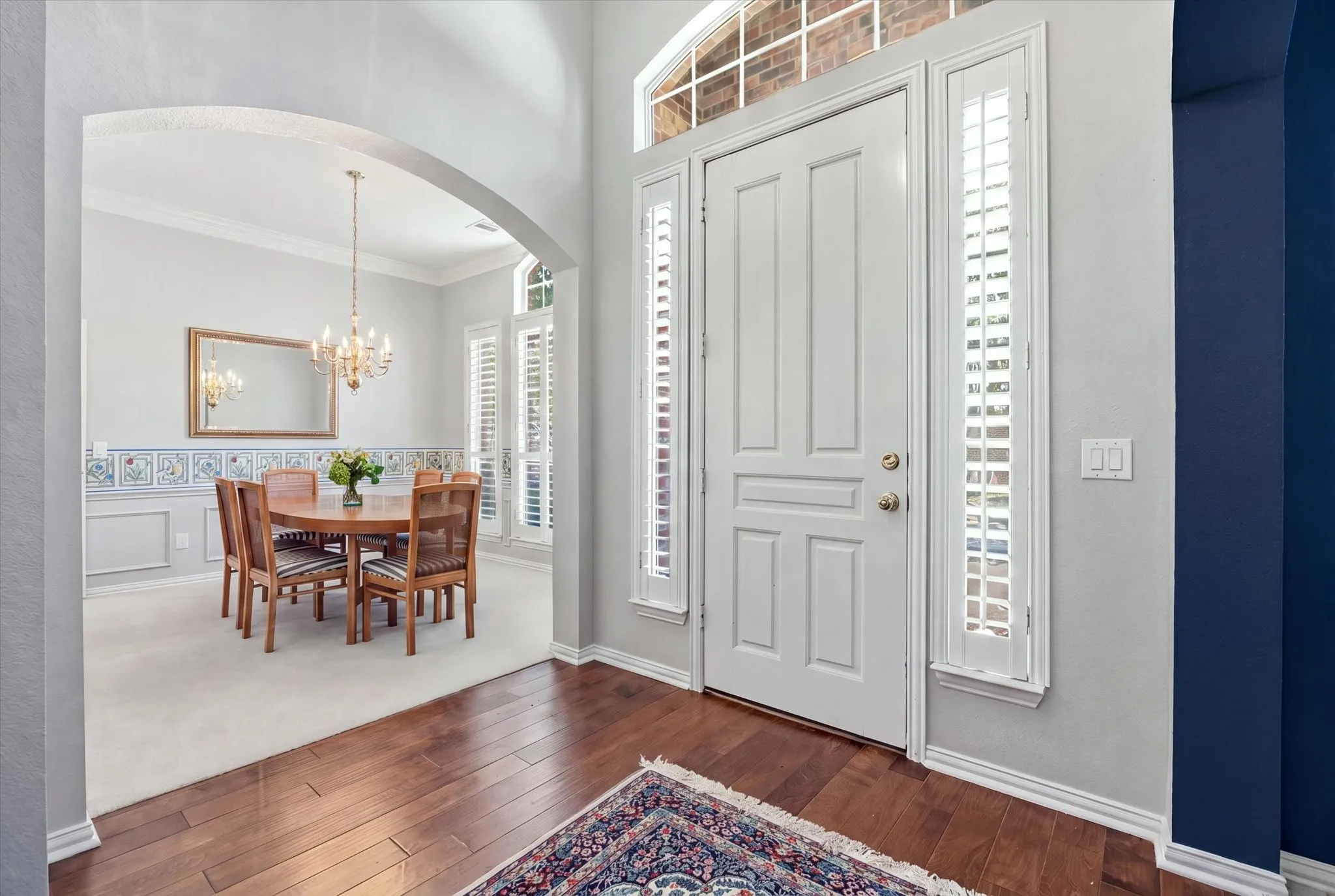 This lovely original-owner home showcases a flexible floor plan with generously sized rooms, plantation shutters throughout, graceful arches, high ceilings, crown molding, gorgeous hardwood flooring and abundance of natural light from its floor-to-ceiling windows.