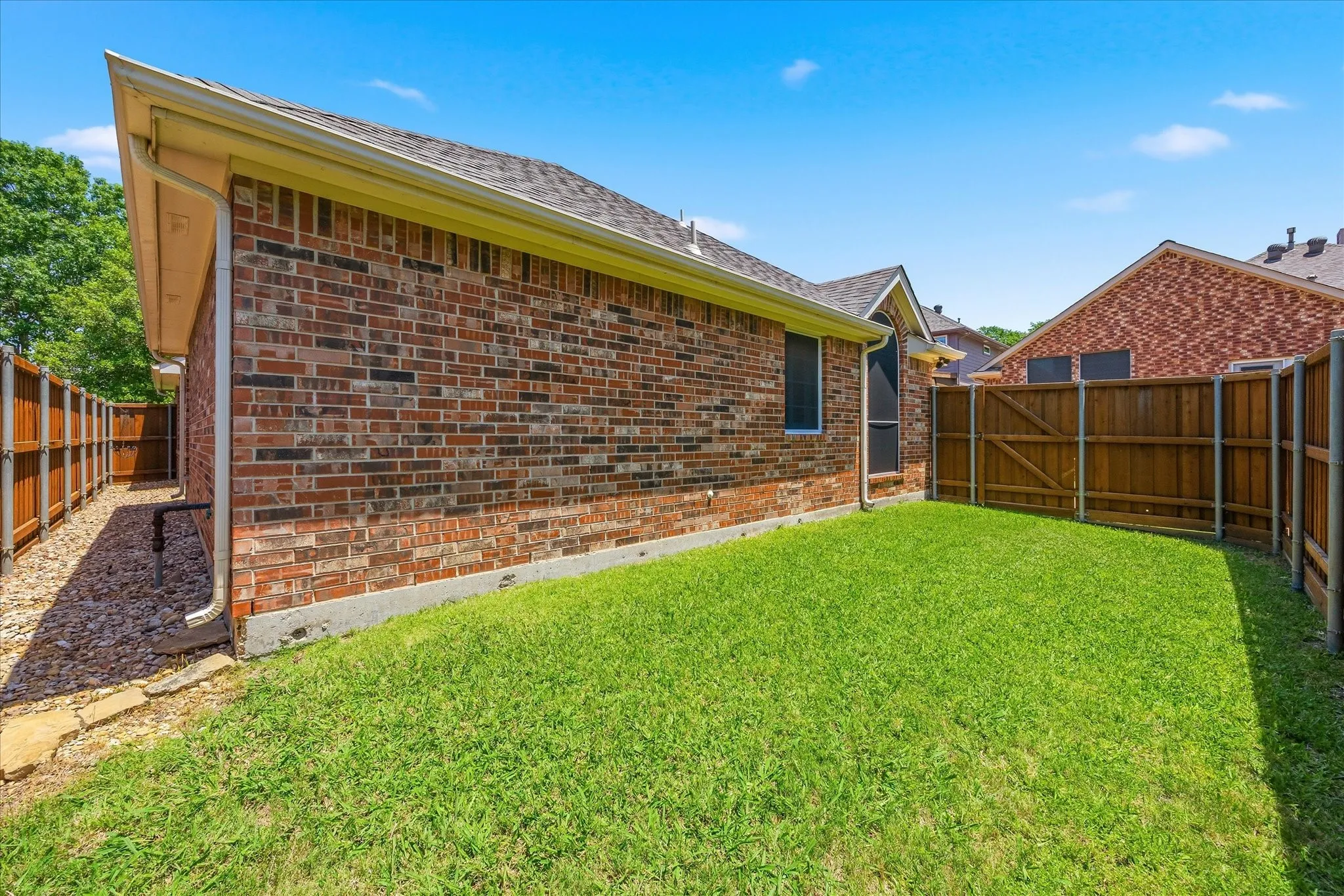 The backyard is low maintenance but has enough space for a pet or gardening.