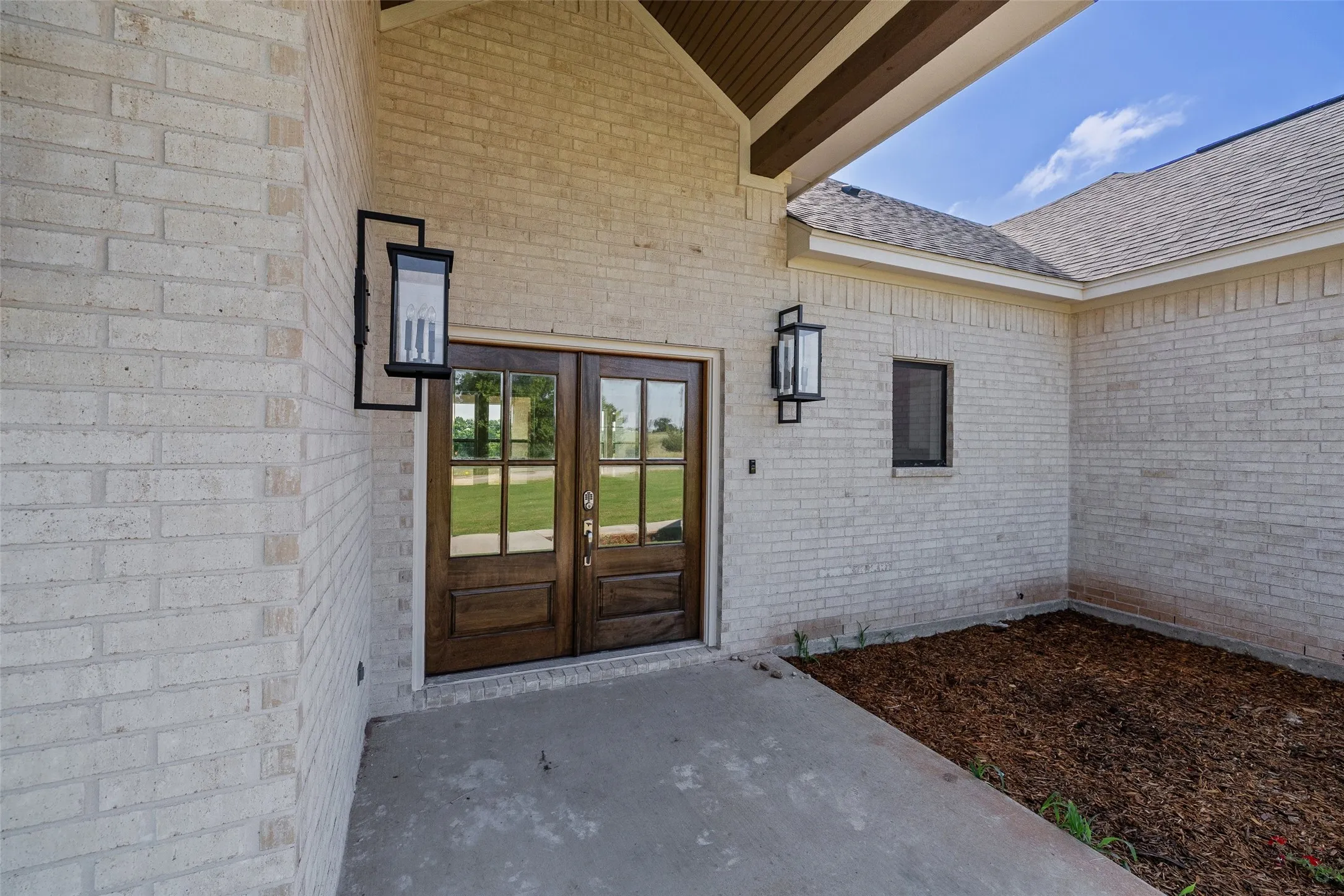 Double entry doors with divided lites and dark wood finish