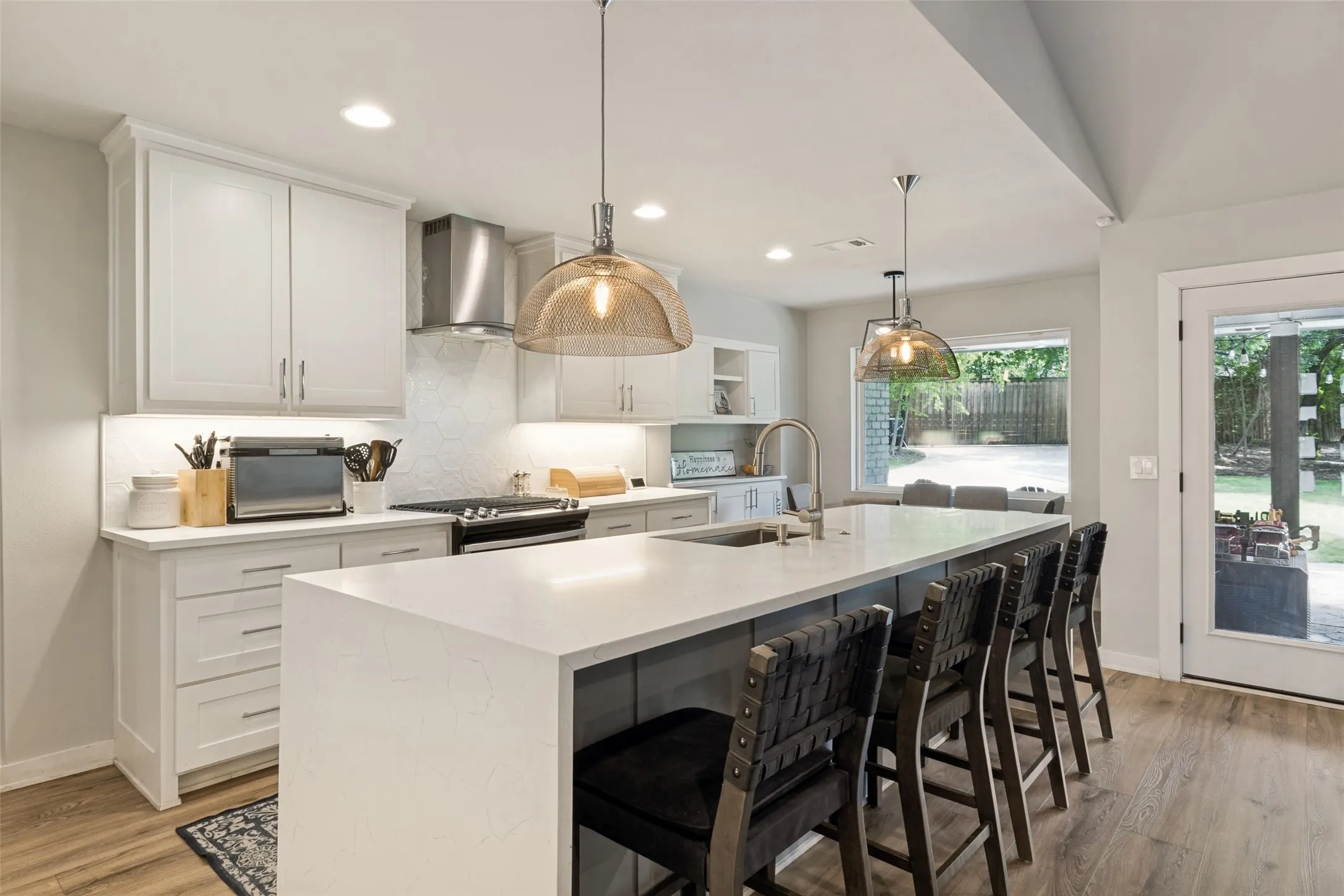 Oversized waterfall island with bar seating provides the perfect gathering space for casual dining, hosting, and everyday connection.