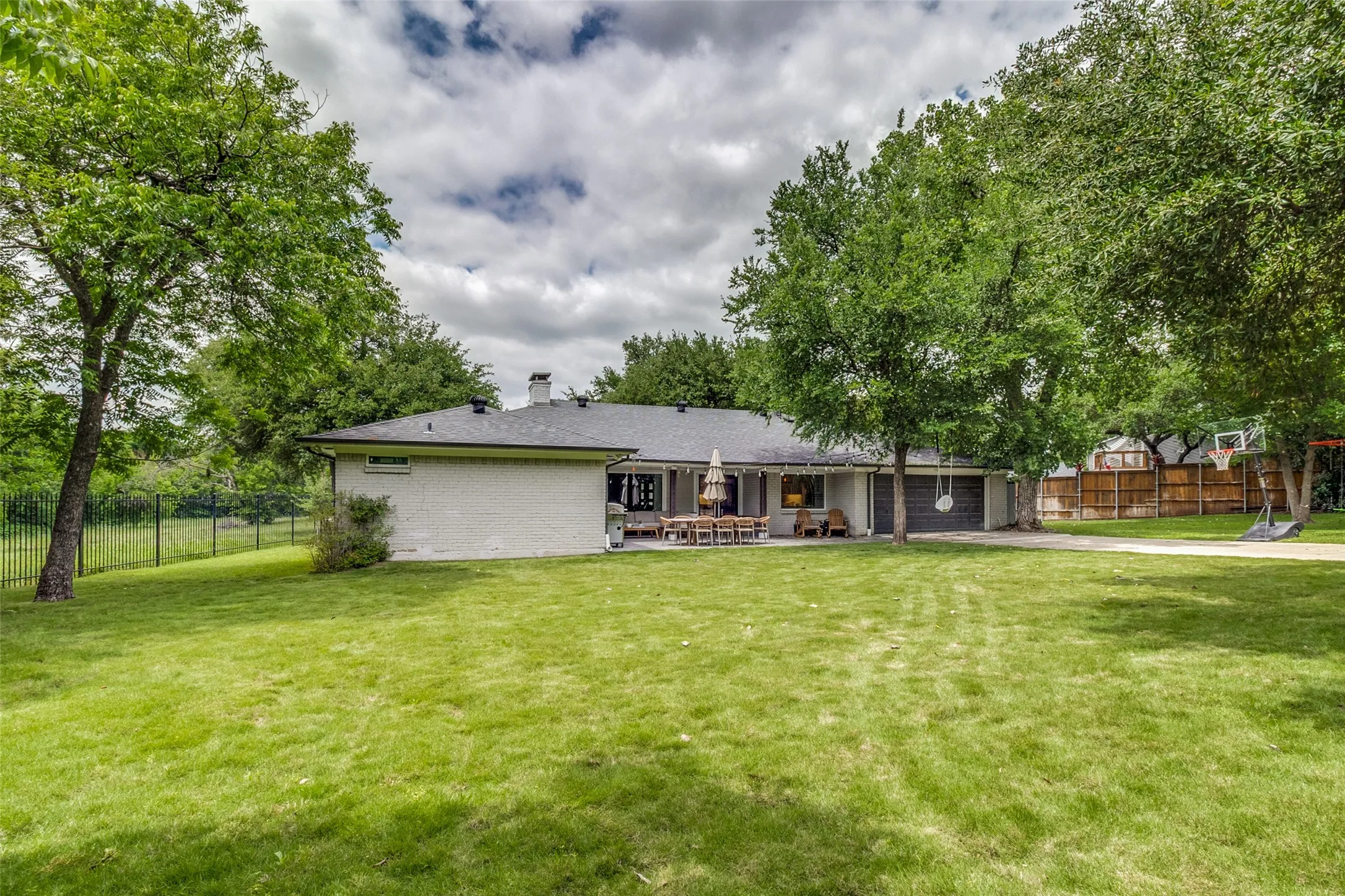 Massive backyard offers endless possibilities for entertaining, play, gardening, or future pool.