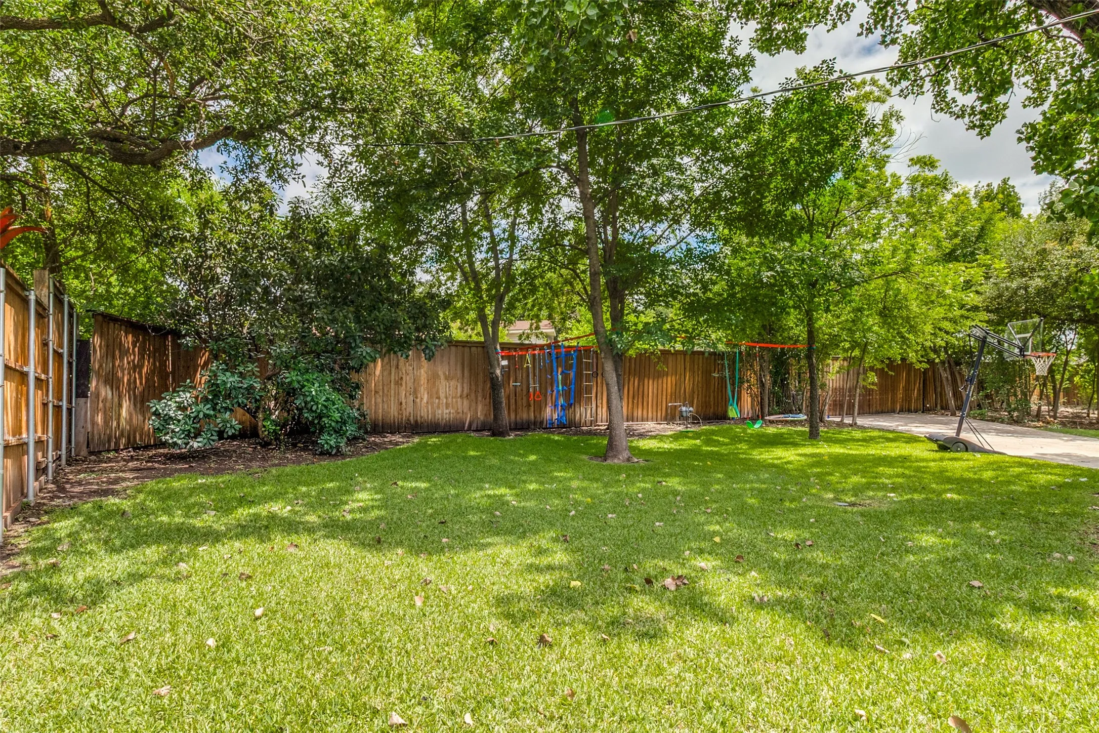 Mature landscaping and towering trees create a peaceful backyard setting with ample room for recreation and entertaining.
